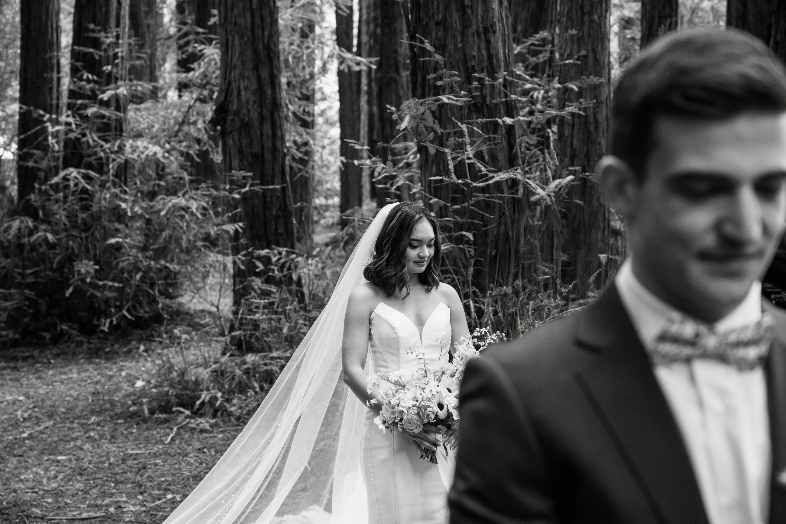 A bride and groom stand in a redwood forest before their ceremony in San Francisco.