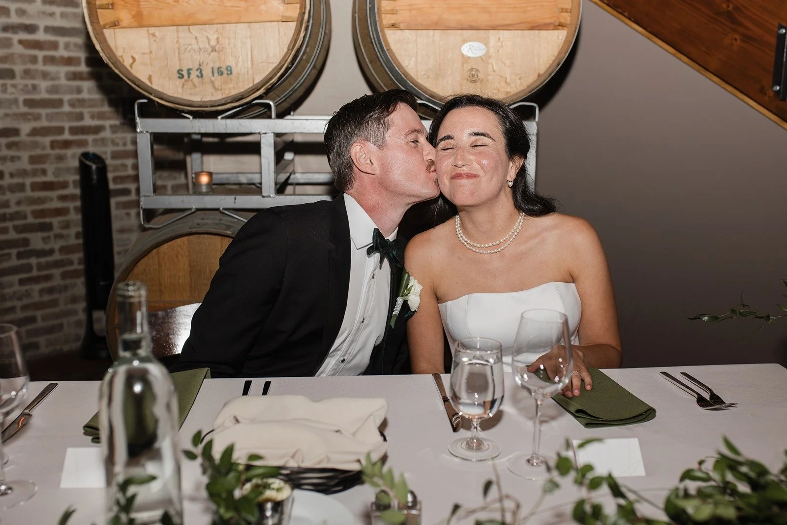 Couple sits at sweetheart table at Domenico Winery in San Carlos.