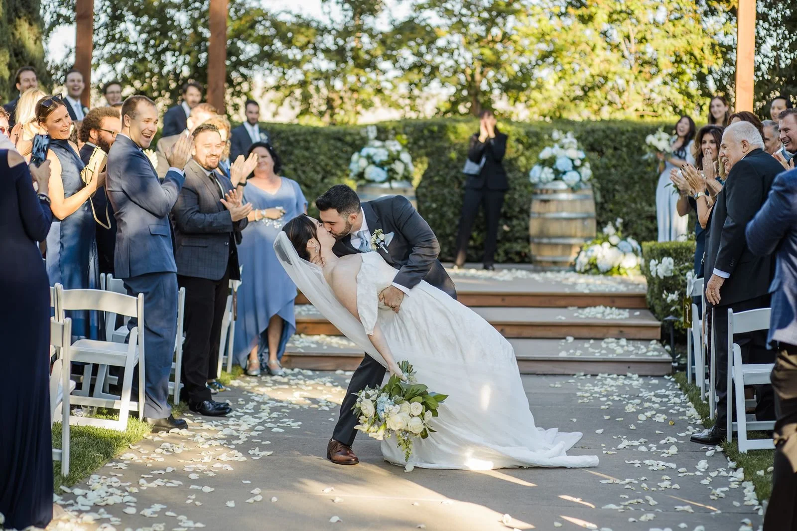 A couple dips for a kiss at the end of the ceremony at a Garre Winery wedding.
