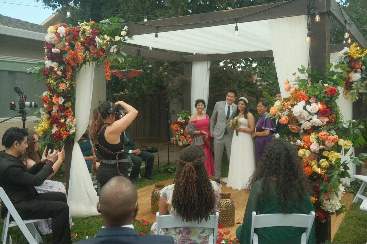 Tangerine Weddings photographer photographing a family.