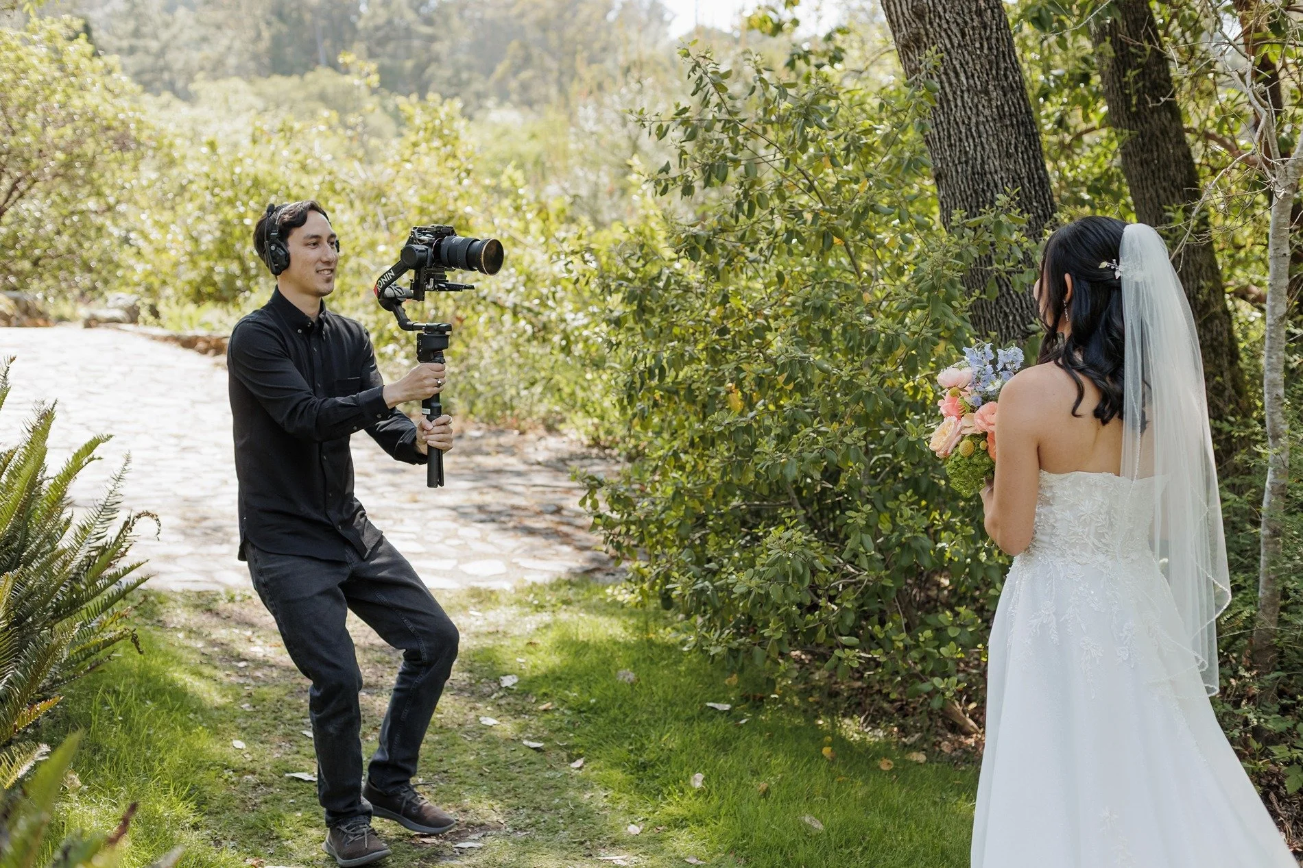 Sean Ayres of Tangerine Weddings holding videography equipment on a wedding day.