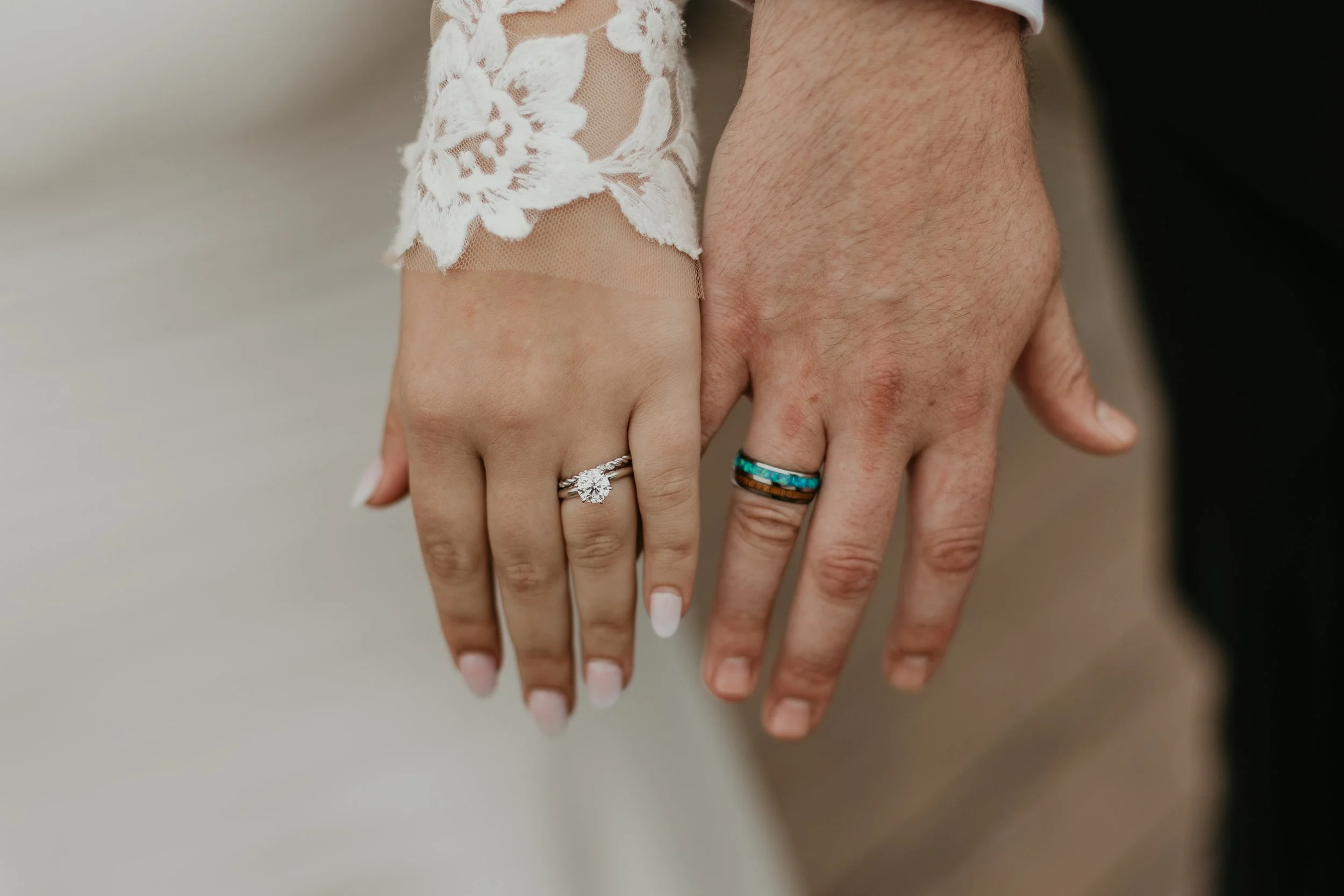 Bride and groom show off their wedding rings in Dana Point.