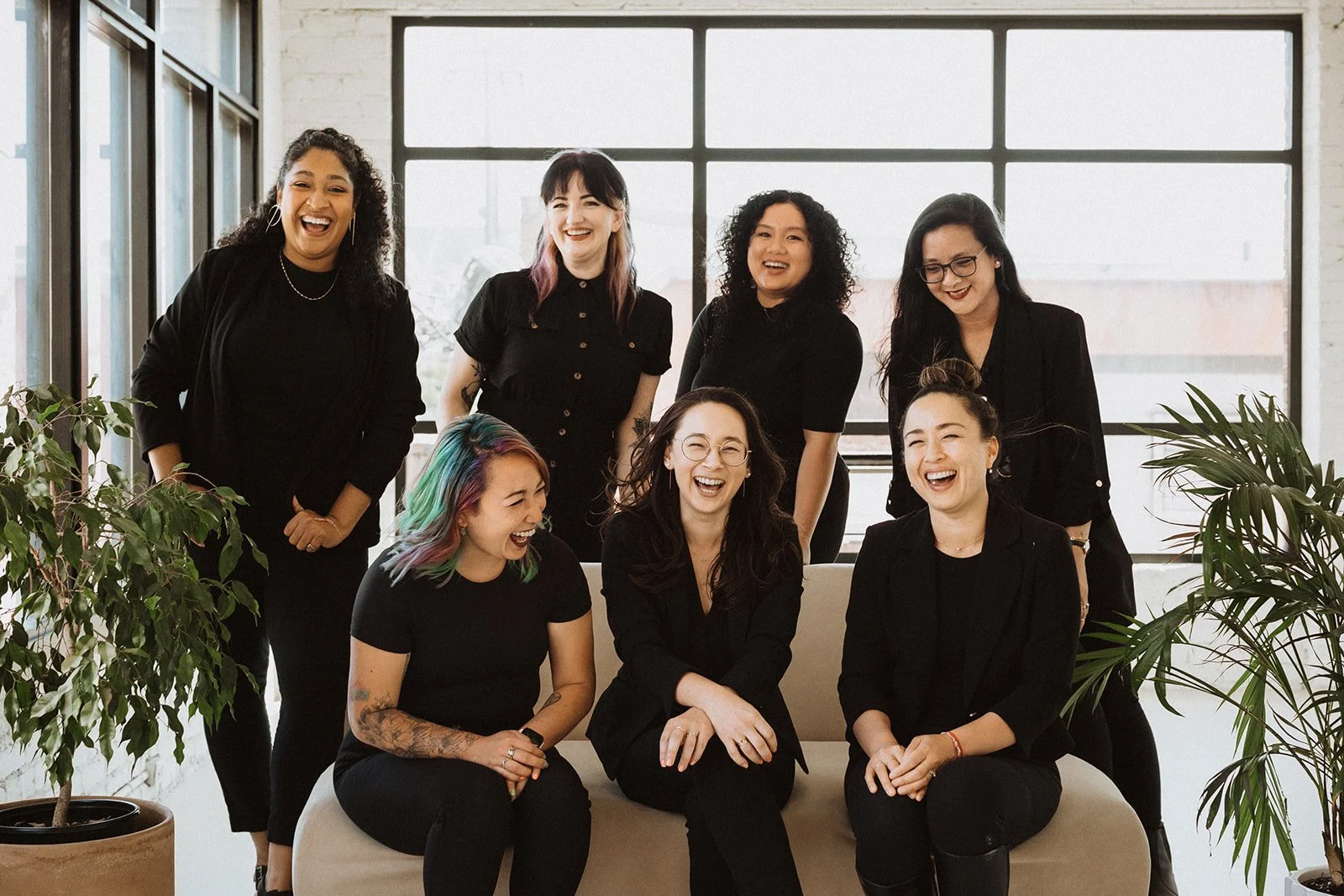 Members of Sachi & Maja sitting and laughing together.