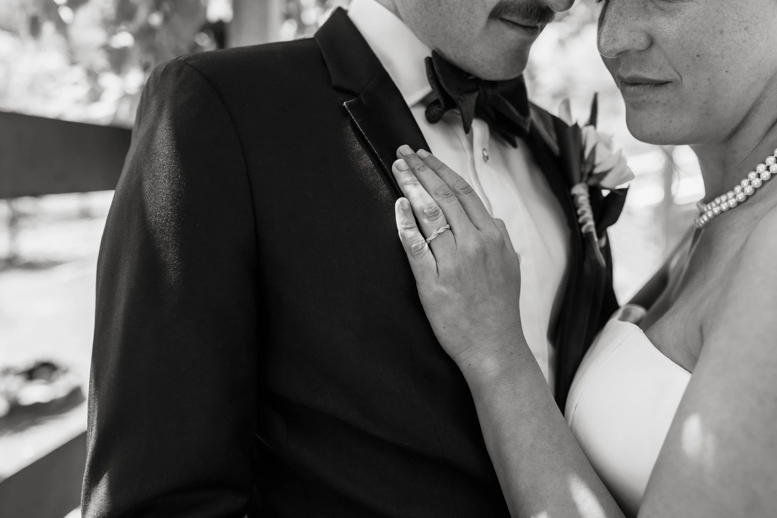 Close up black and white photo of couple embracing.