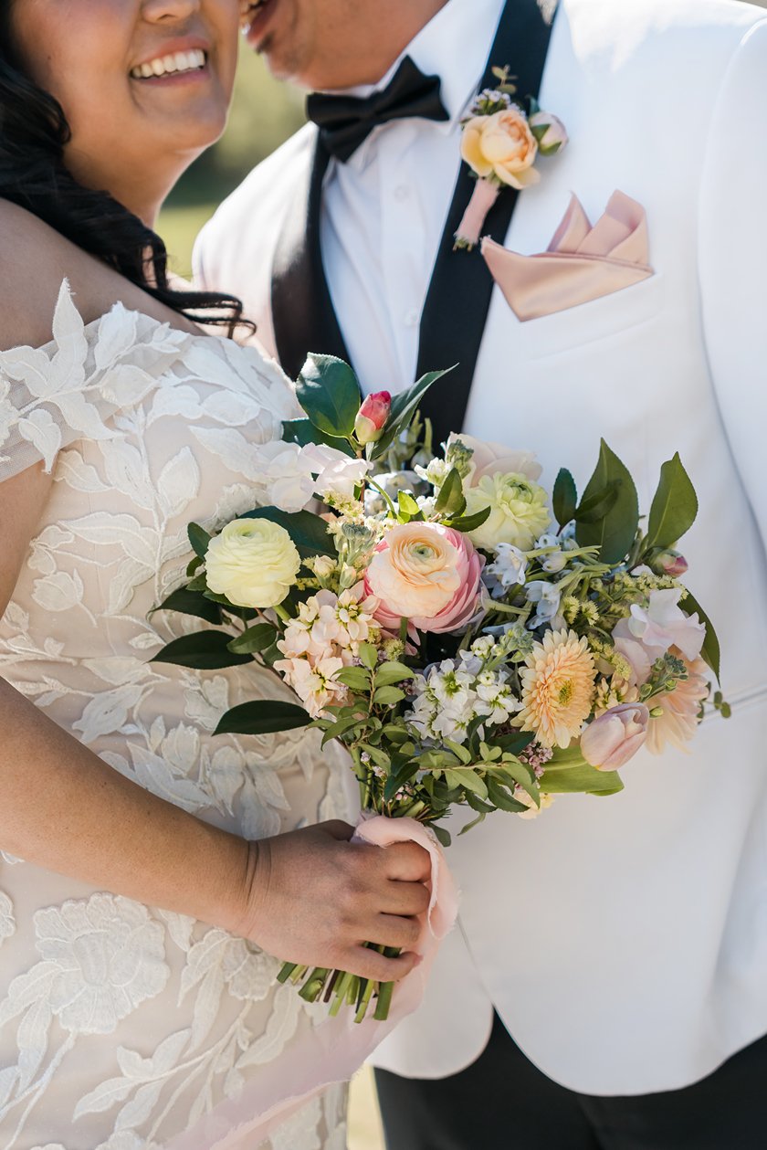 A couple poses for photos at their wedding at The Club at Ruby Hill in Pleasanton.