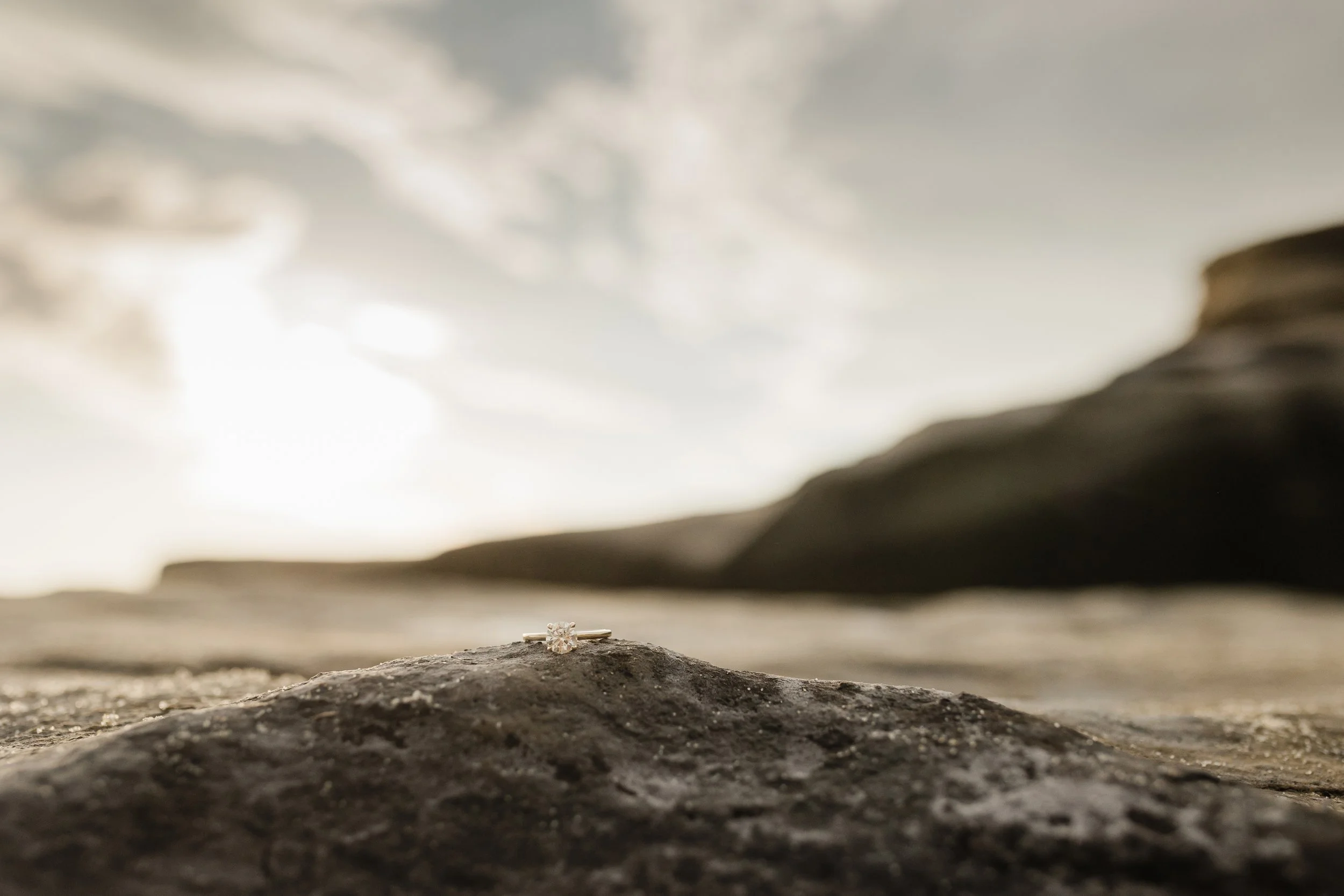 Engagement ring sits on a rock in La Jolla.
