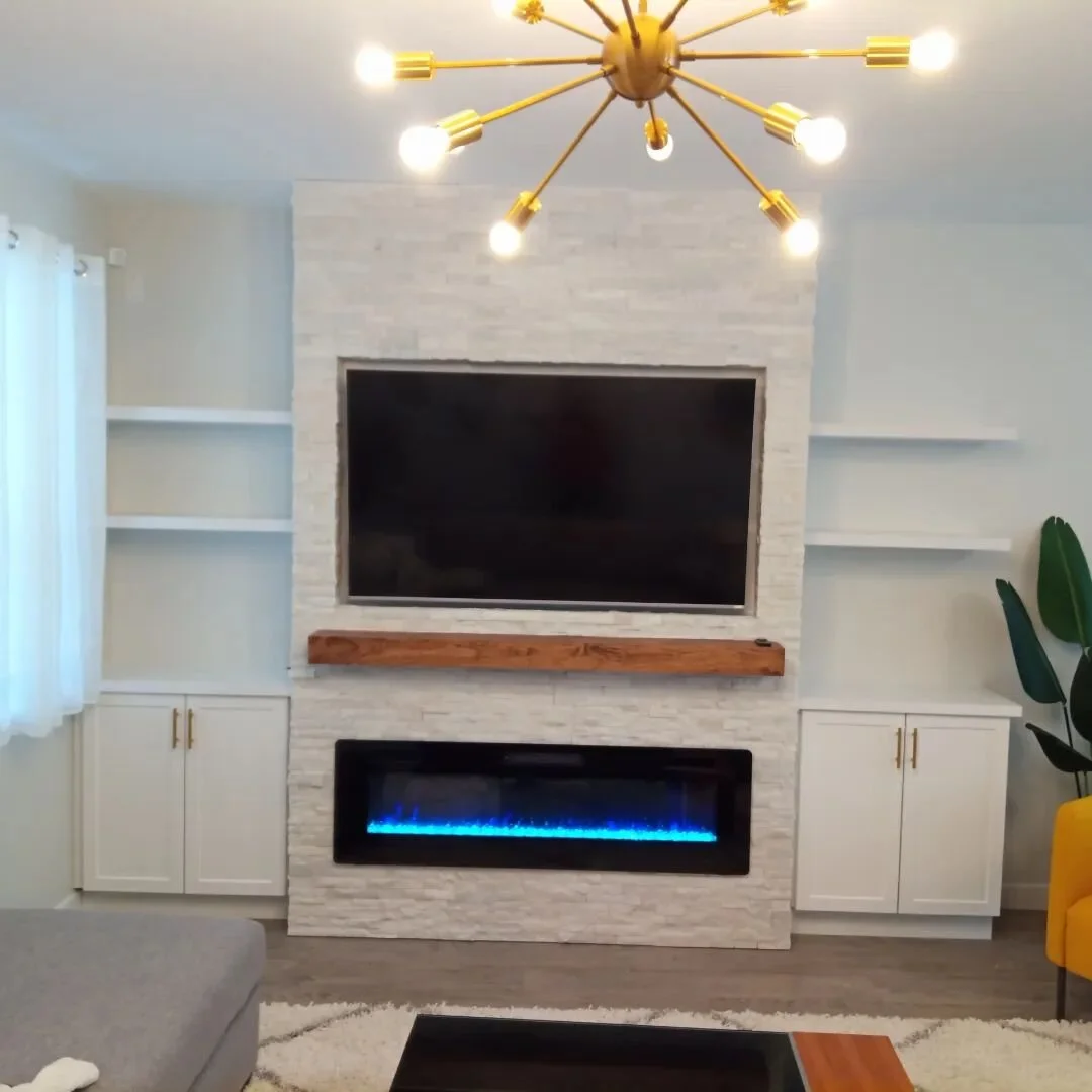 We were approached to build this fireplace onto this blank canvas of a wall. We think the results speak for themselves. We started with steel stud framing and fire rated drywall prior to cladding with styling stack stone, floating shelves, a wood man