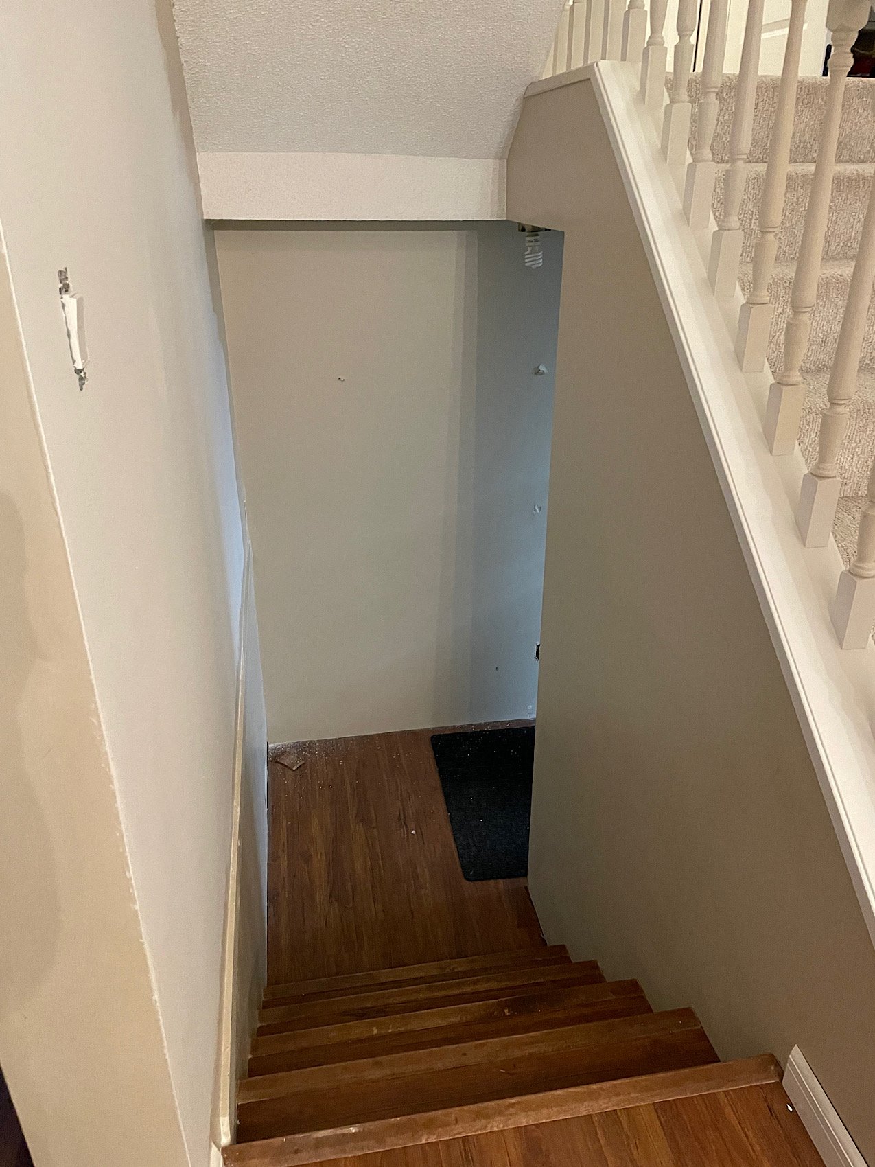 Before - small hallway with no space! The garage door is down to the right. No where to put shoes and coats as you come in from the garage, and laminate floor that doesn't do well as snow and water get tracked in...