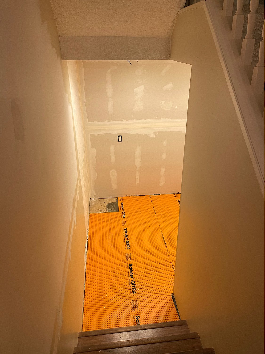 During - new drywall up, Schluter Ditra crack prevention installed for under tile