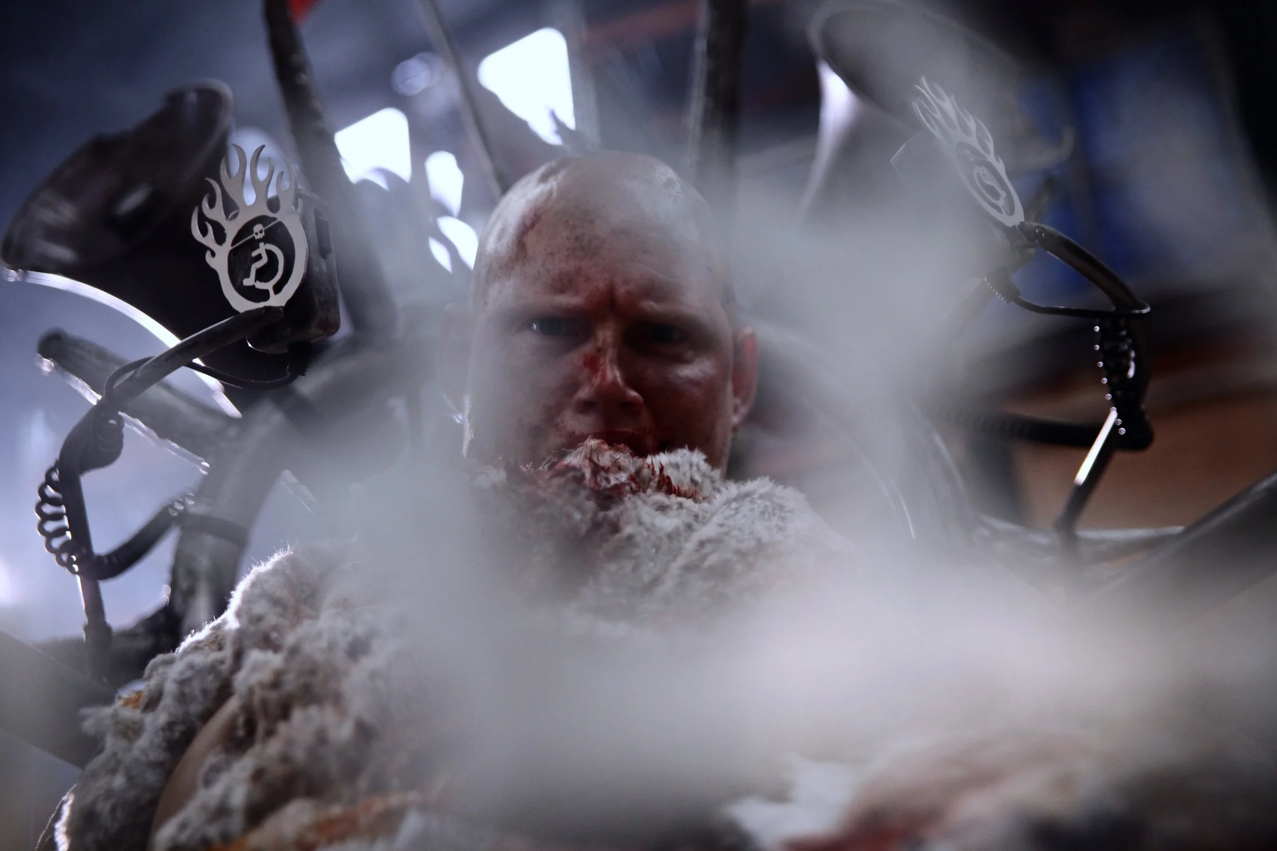 Metal flames are blurred out revealing my eyes which are angry. My apocalyptic wheelchair is a big metal object, with sharp edges and spikes, with 2 megaphones.