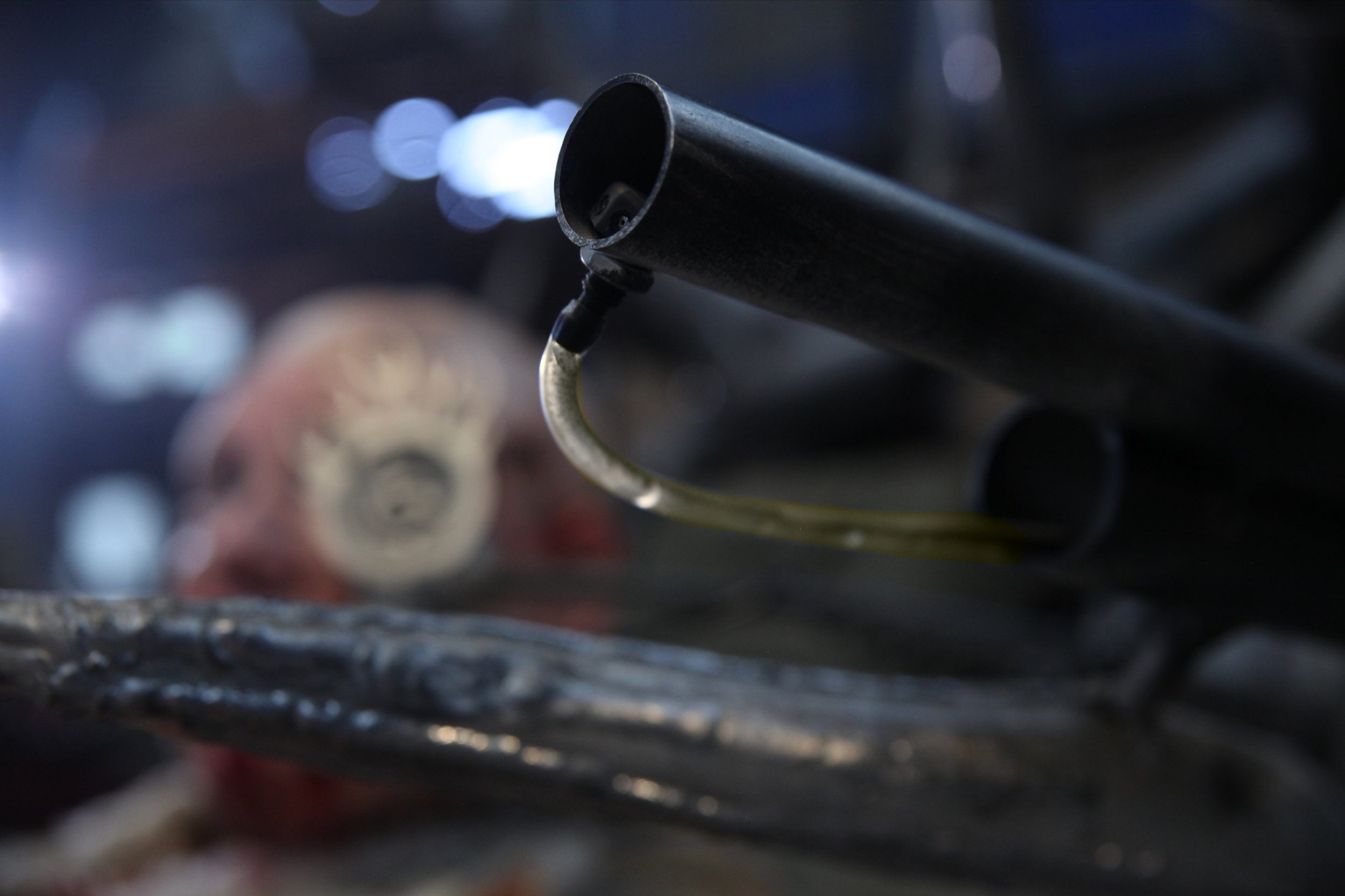 A close up of my apocalyptic wheelchair shows a plastic tube with yellow liquid pumping into the barrel of a gun.