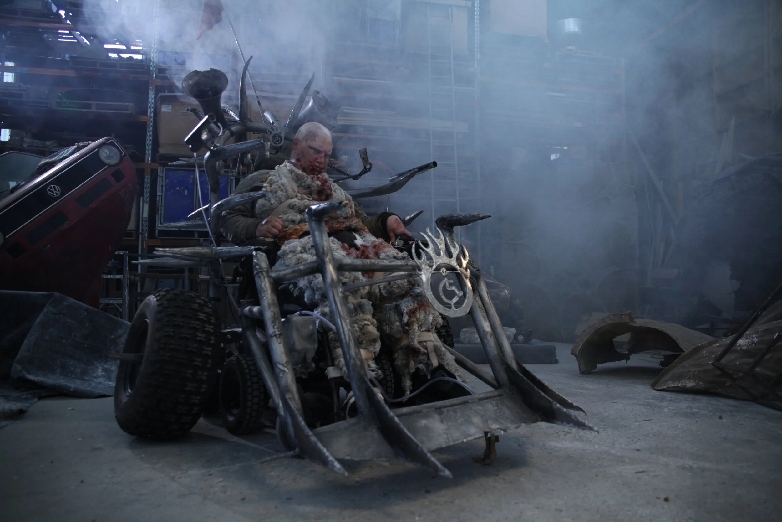The front of my apocalyptic wheelchair has spiked bullbars, there is smoke surrounding me like it is the end of the world.
