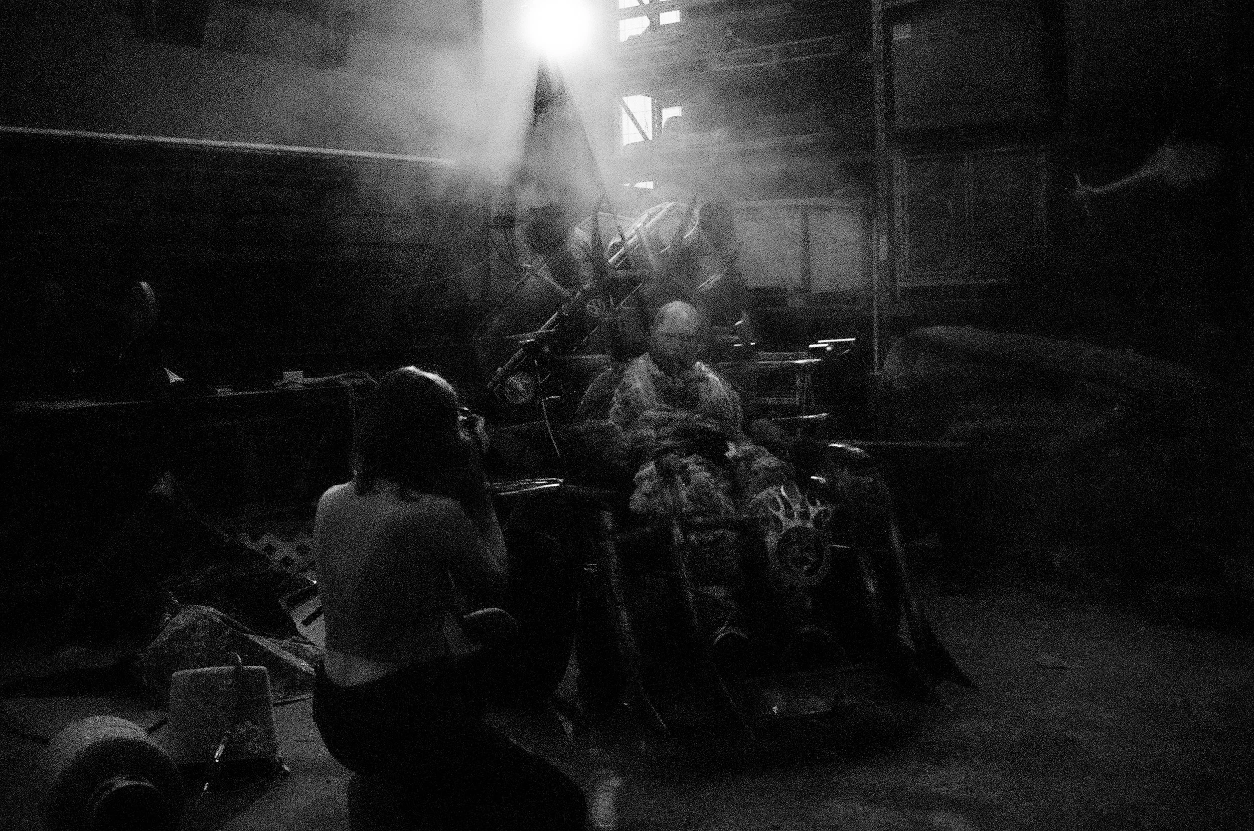 A photographer kneels in front of me to get a good shot of my smoke-hazed image.