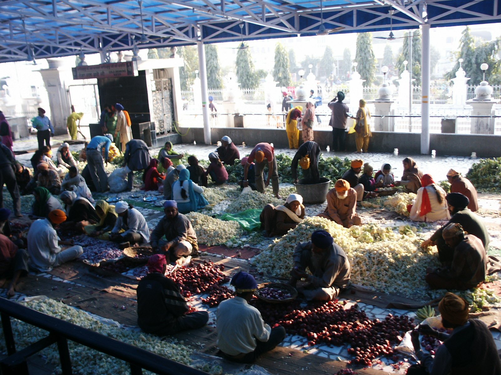 A_group_of_volunteers_helping_with_daily_food_preparation_for_Langar_at_the_Golden_Temple.jpg