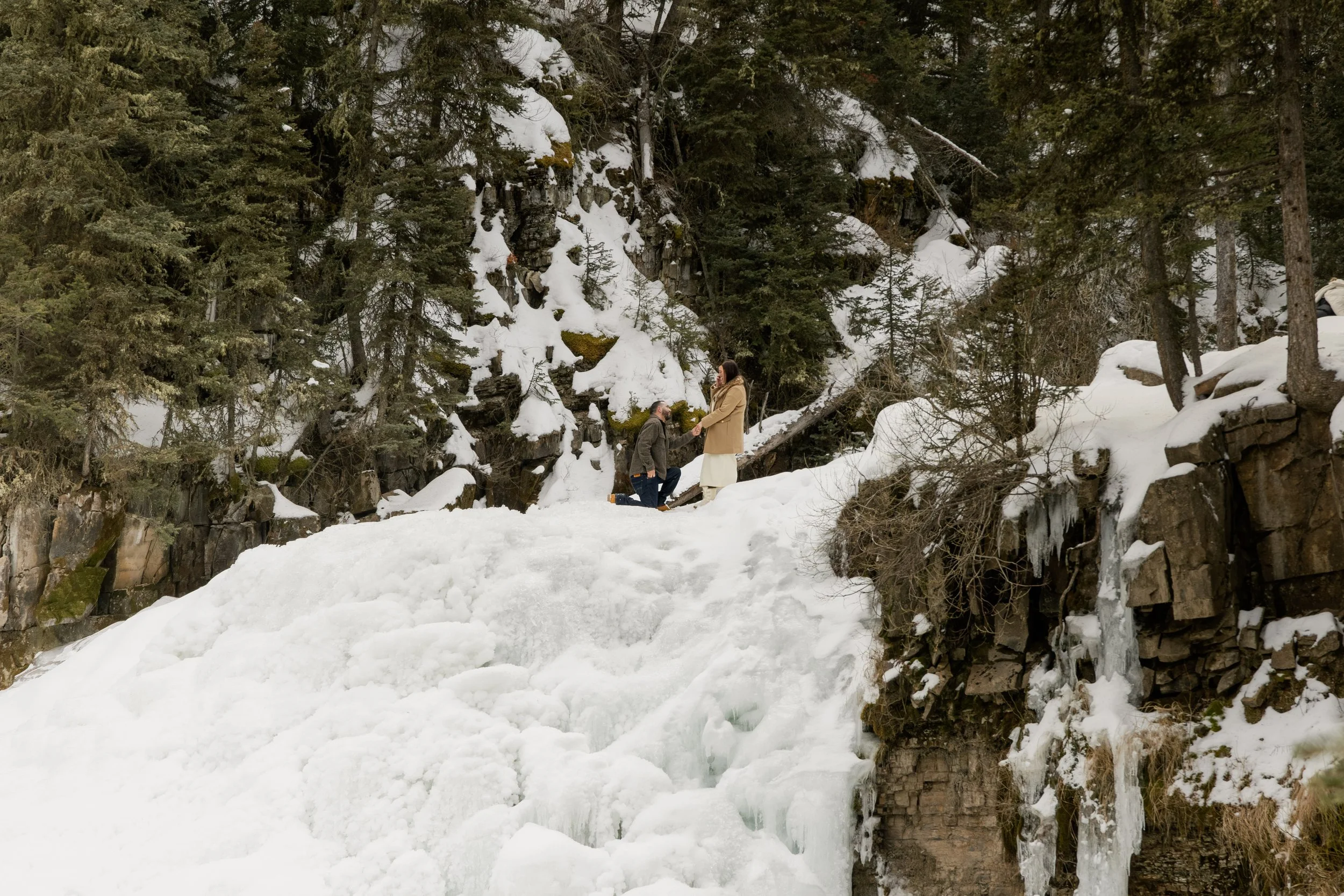 Lauren &amp; Aaron’s Surprise Birthday Proposal at the Top of the Frozen Waterfall in Big Sky, Montana