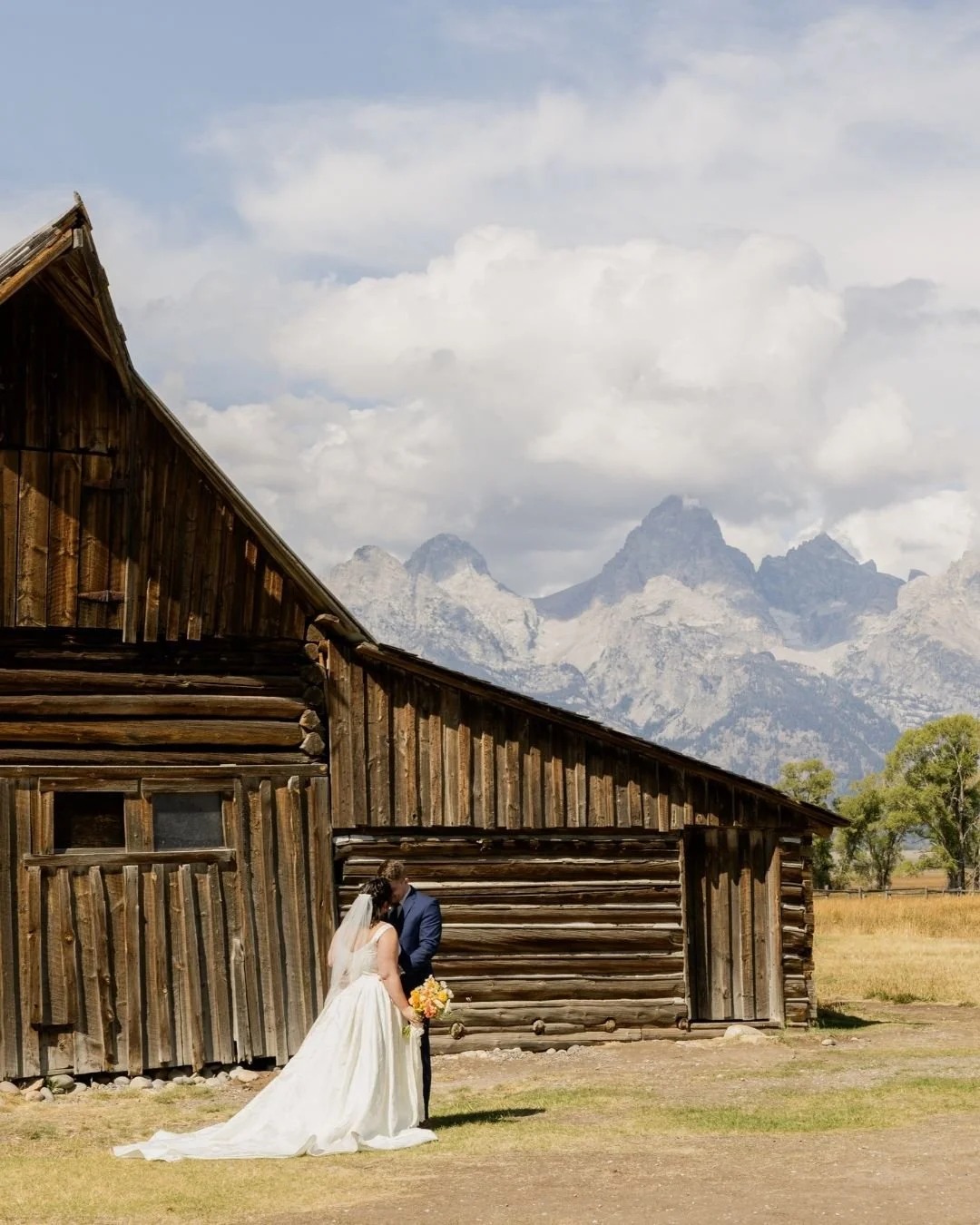 Bride and groom at barn in Tetons National Park