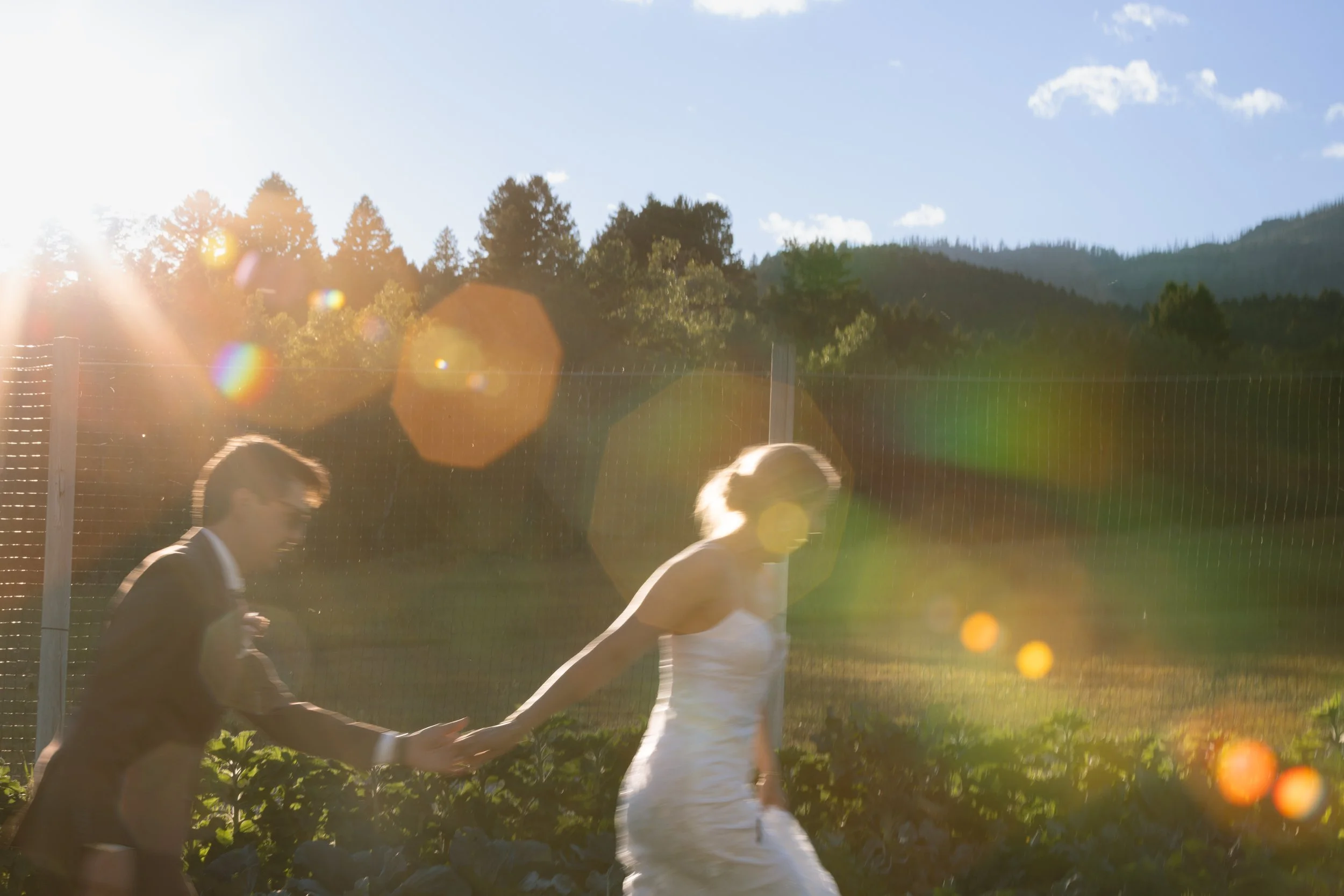 Bride and groom running in private property in Bridger Mountain outside of Bozeman Montana captured by Alyssa Johnson Photographer ( Bozeman Wedding Photographers)