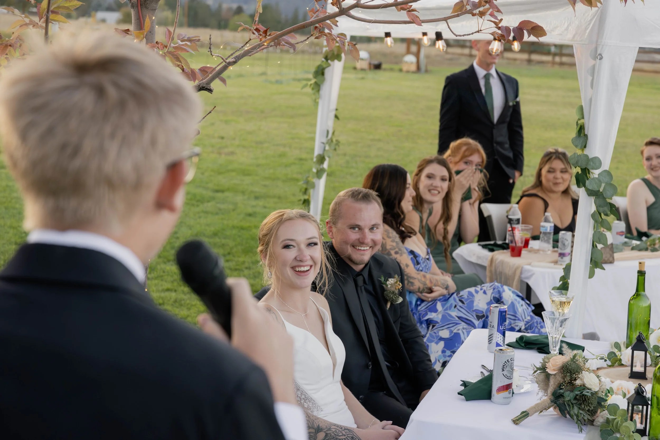 wedding couple smiling during the speech - capture by Alyssa Johnson Photography