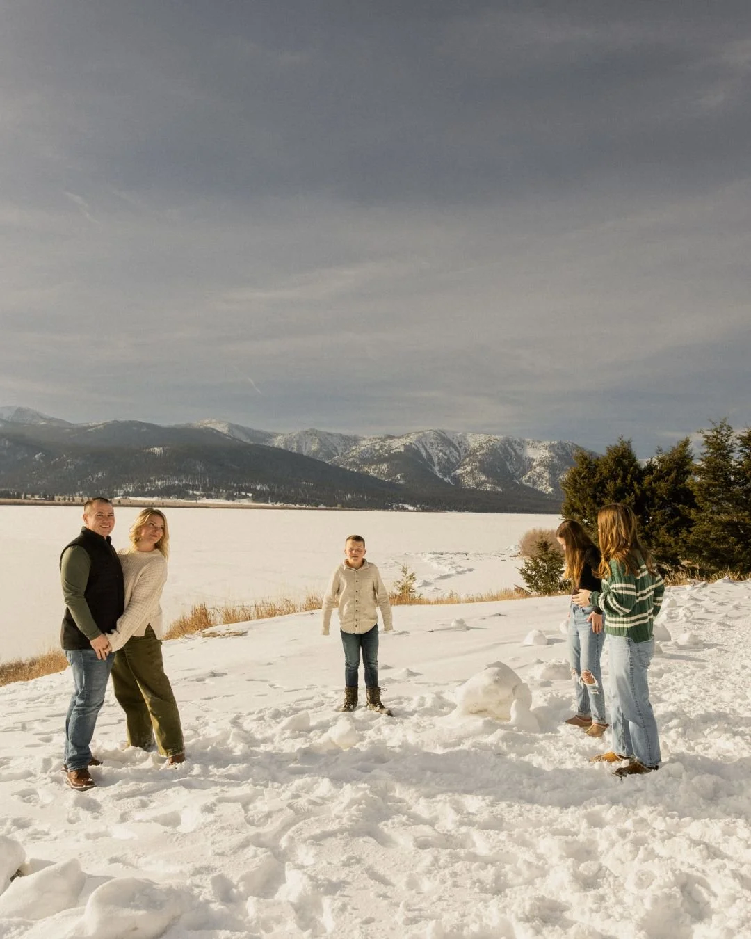 Winter family photo in the snow in West Yellowstone, Montana