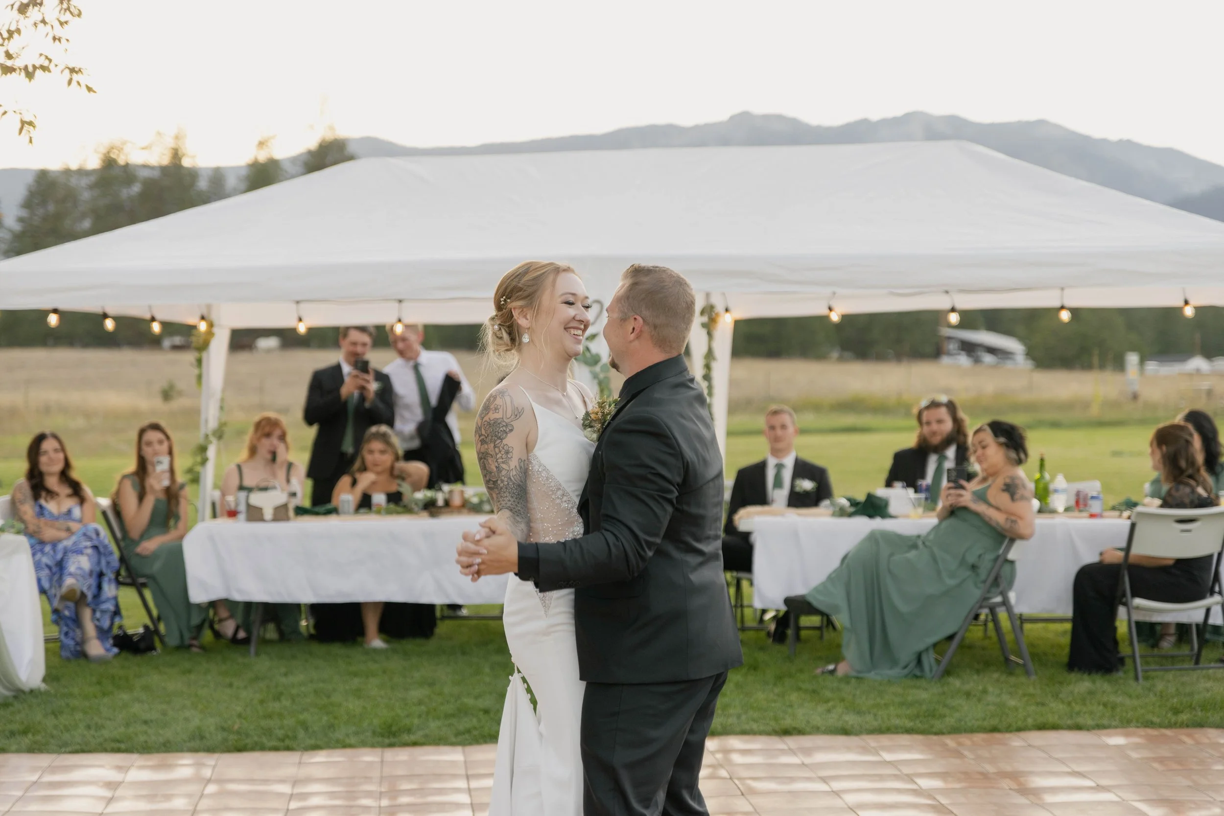 Bride and groom first dance in field at Victor Montana captured by Alyssa Johnson Photography