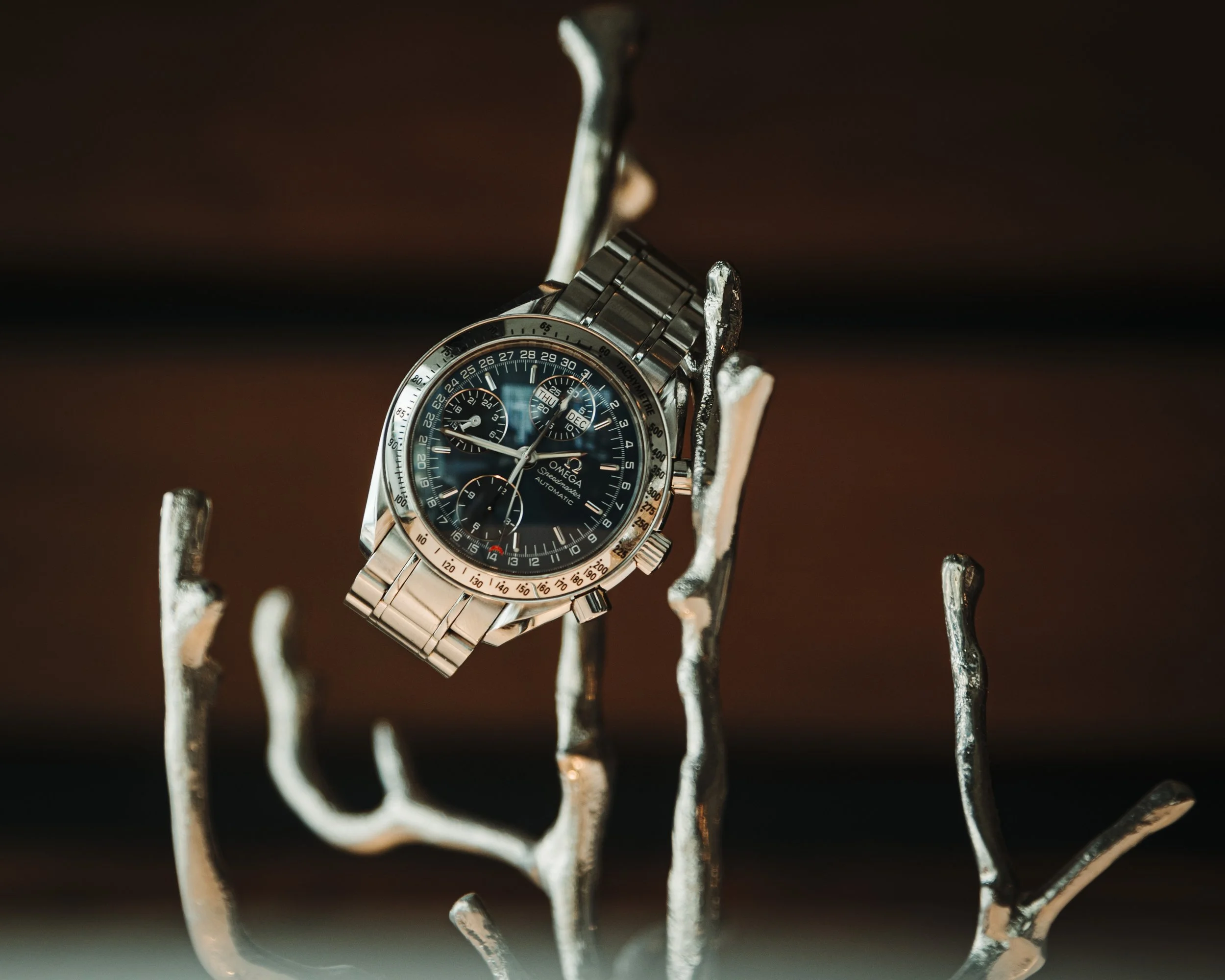 Omega Speedmaster product photography on a piano in Charlotte, North Carolina