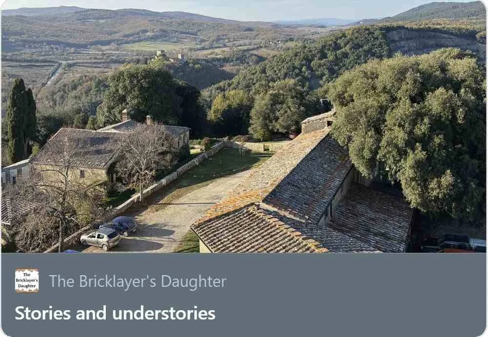 Italian countryside, a roof, the tops of tress, and rolling hills.