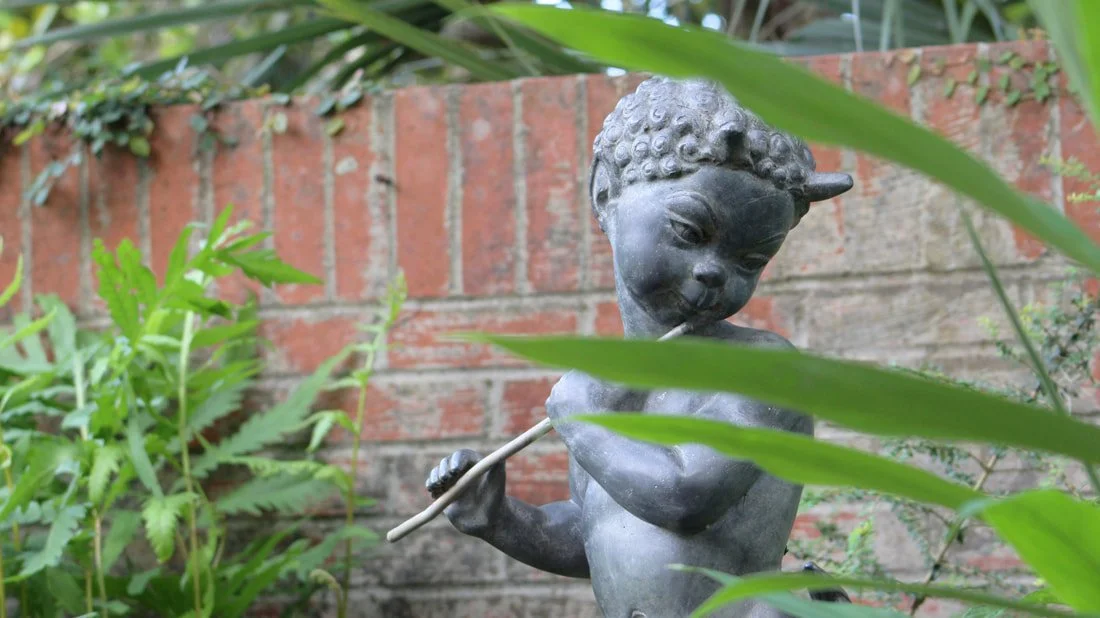 A baby satyr plays a quiet song in Brookgreen Gardens, South Carolina.