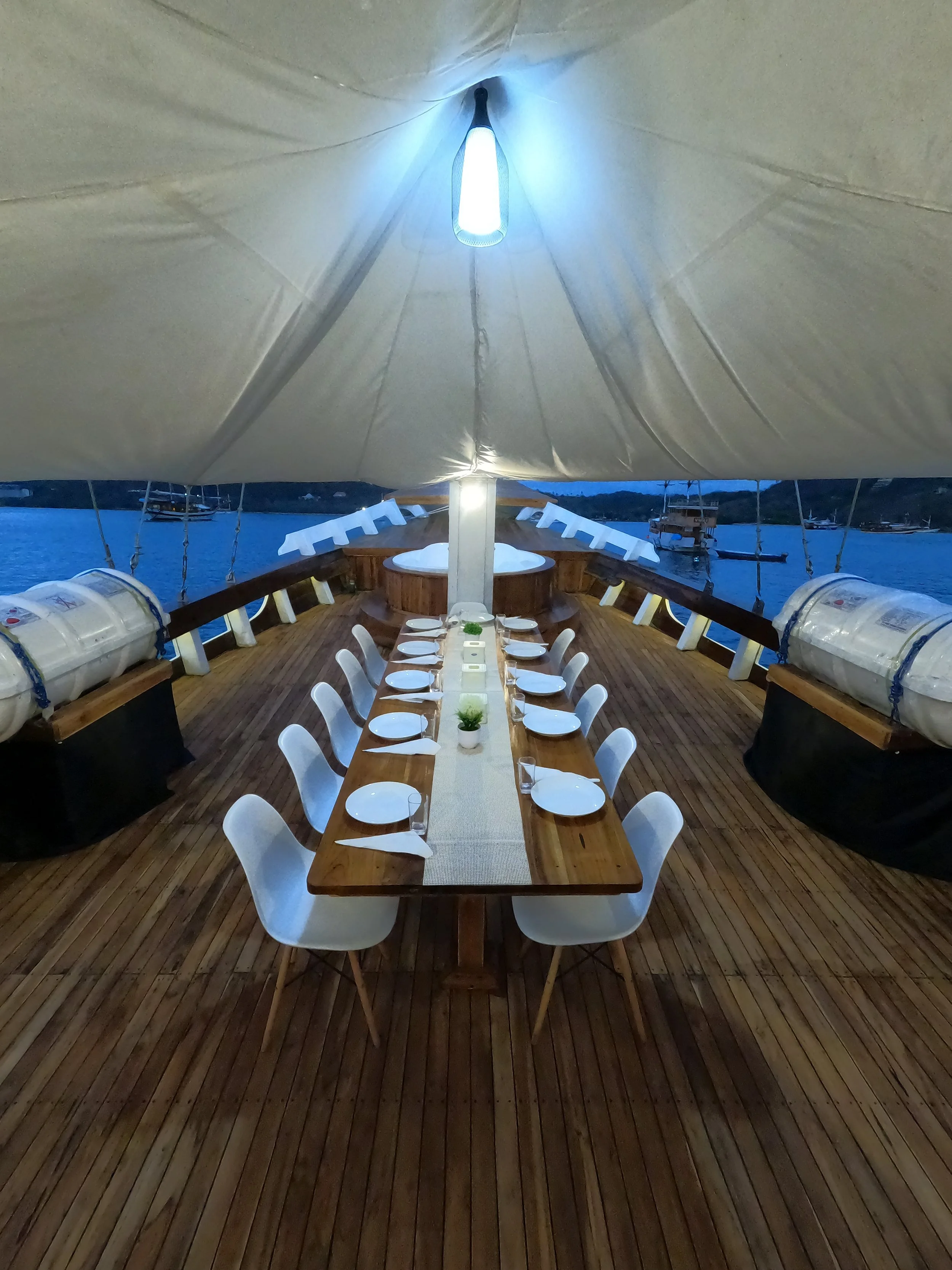 Open dining area onboard premium Komodo sailing liveaboard with ocean views
