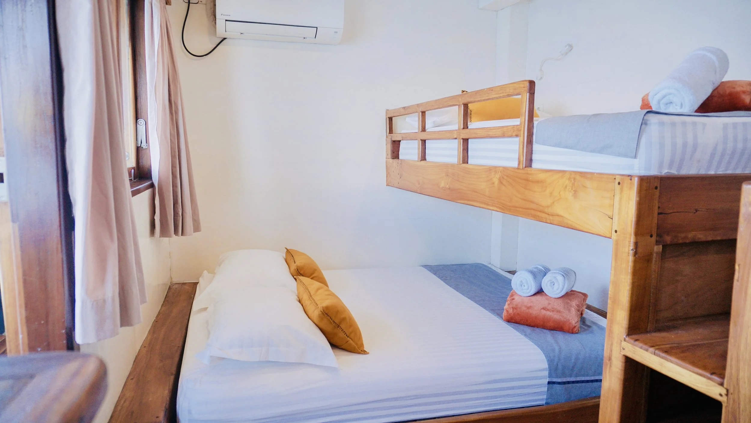 Air-conditioned sharing cabin onboard signature Komodo sailing liveaboard experience