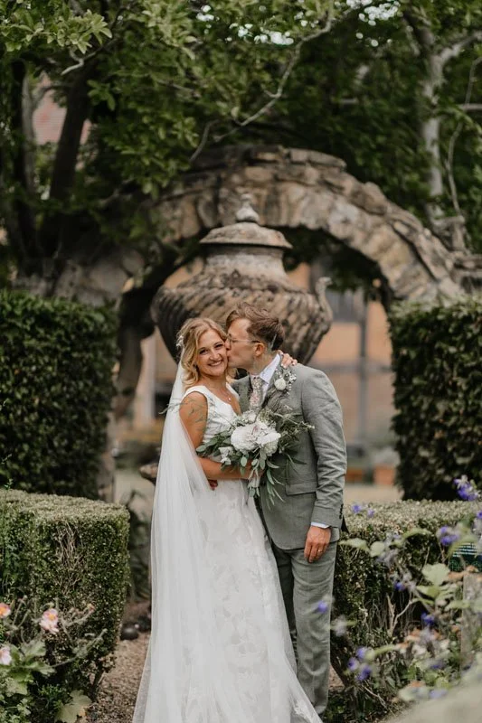 a bride and groom sharing a moment in the Masters garden at the Lord Leycester