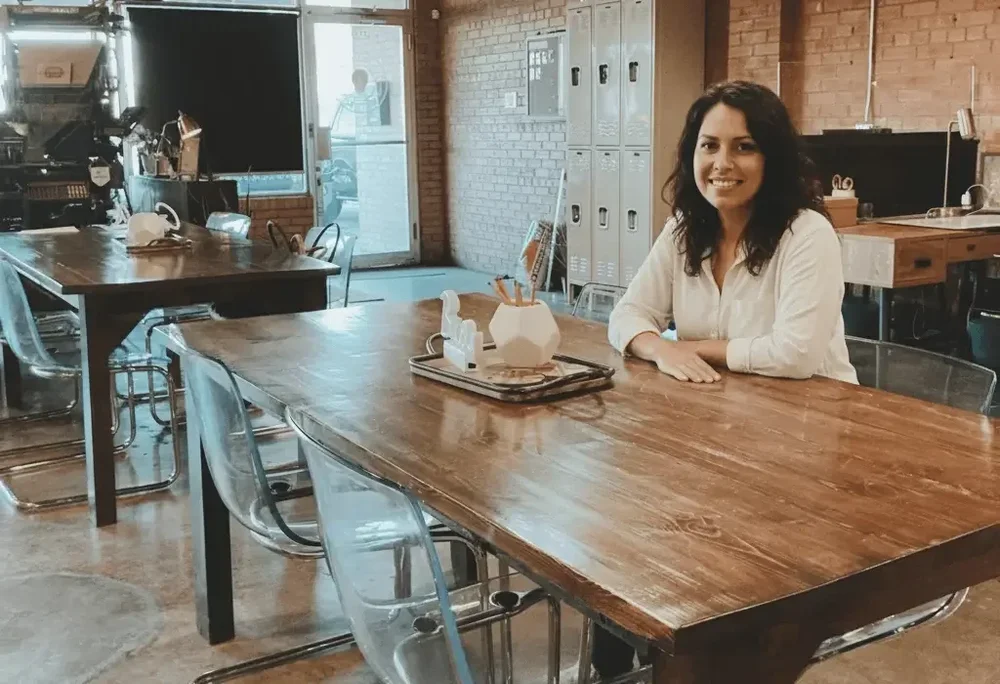 A member working at a shared coworking table at Union Hall Workspace in Amarillo