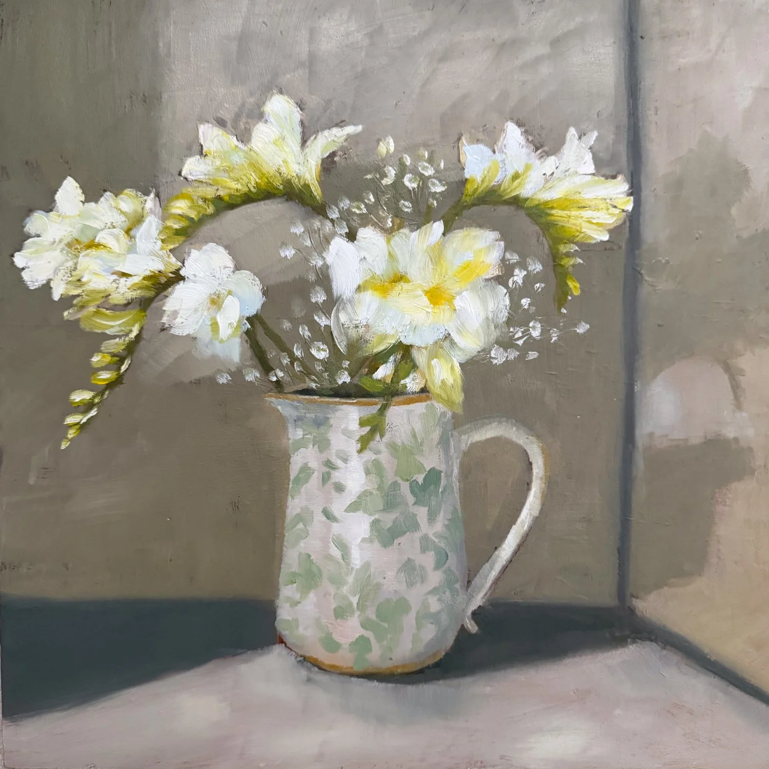Freesias in green & white jug