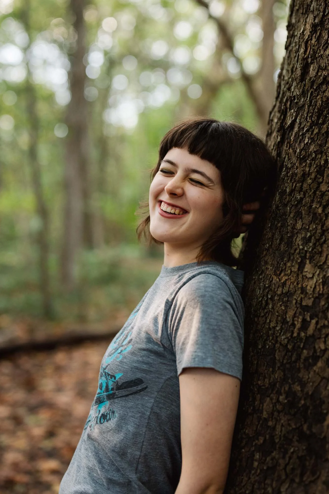 teen laughing joyfully during an outdoor senior photo session in Columbus with Heart Sung Photography