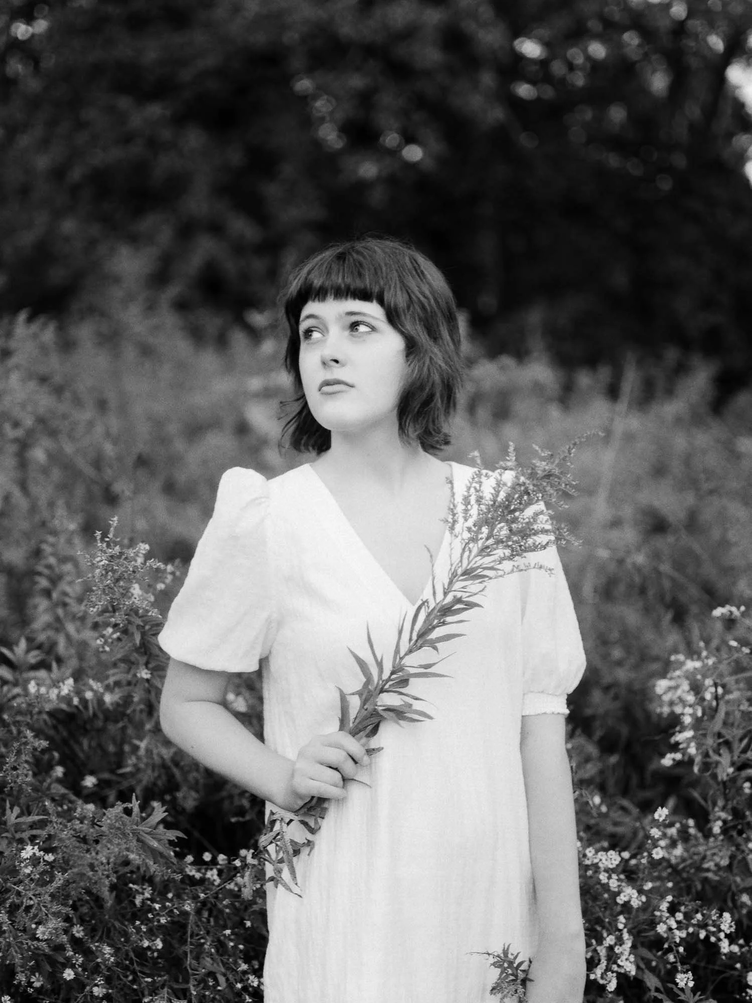 Columbus senior looking confident and authentic in personal style during portrait session outdoors image on black and white film
