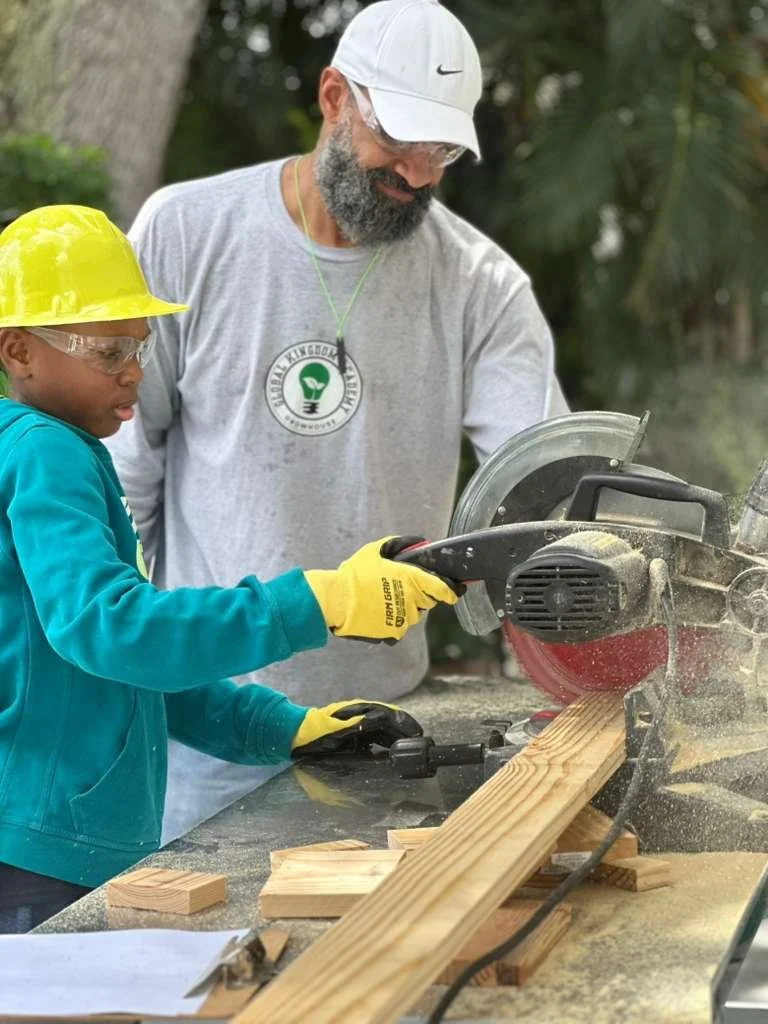 Jason Allen guides students during a hands-on woodworking activity.