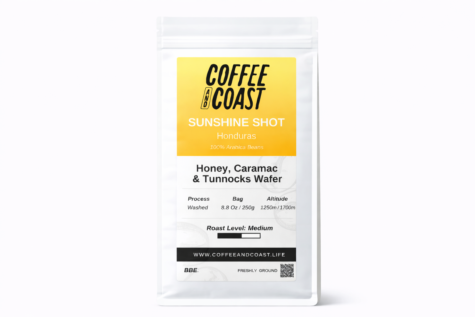 A package of Coffee and Coast Sunshine Shot Honduran coffee beans, describing it as honey, caramel, and Tunnocks wafer flavor, with details about processing, bag weight, altitude, roast level, and website.