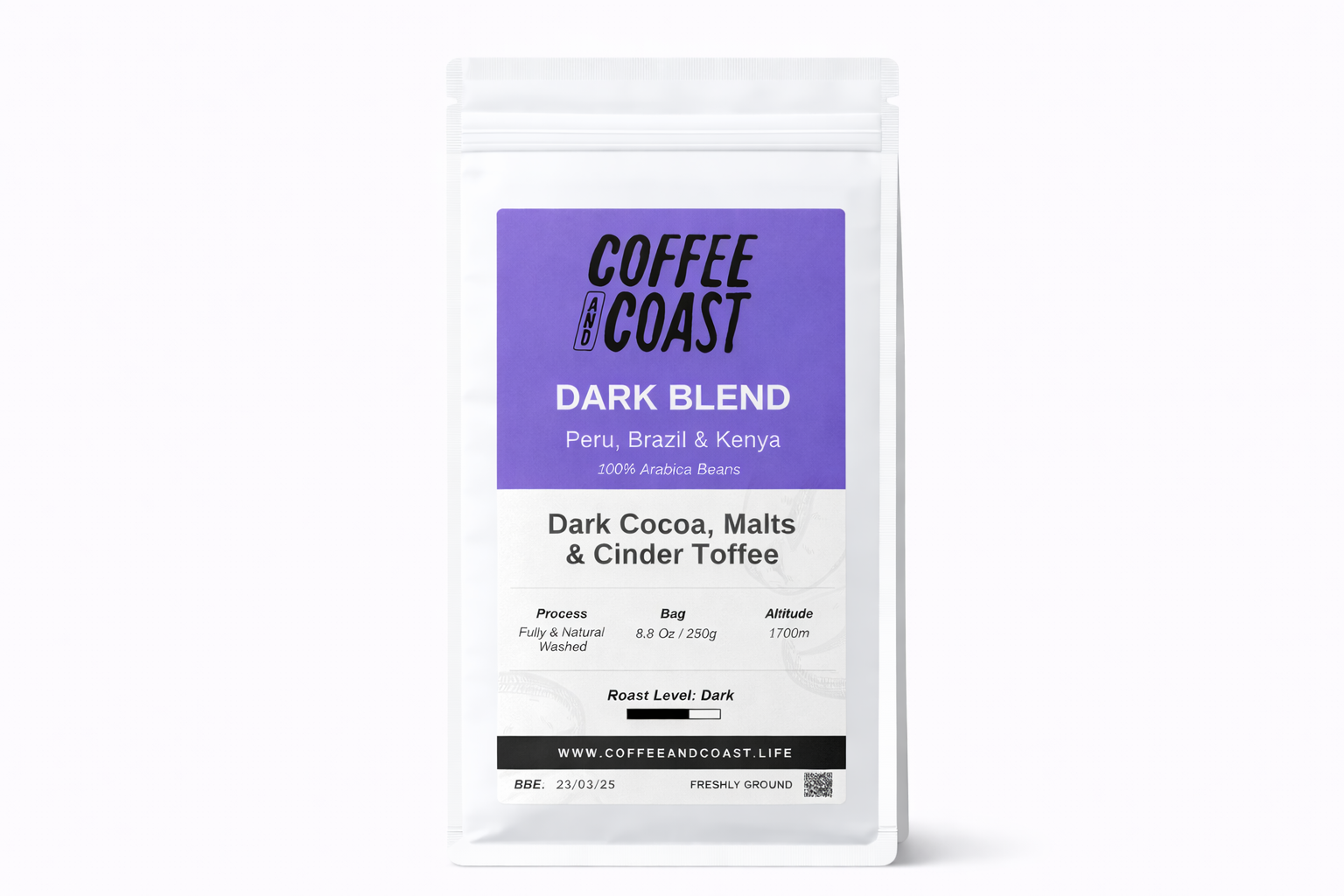 A white package of Coffee and Coast Dark Blend coffee beans with purple label, featuring black and white text about the coffee's origin, processing, and flavor profile.