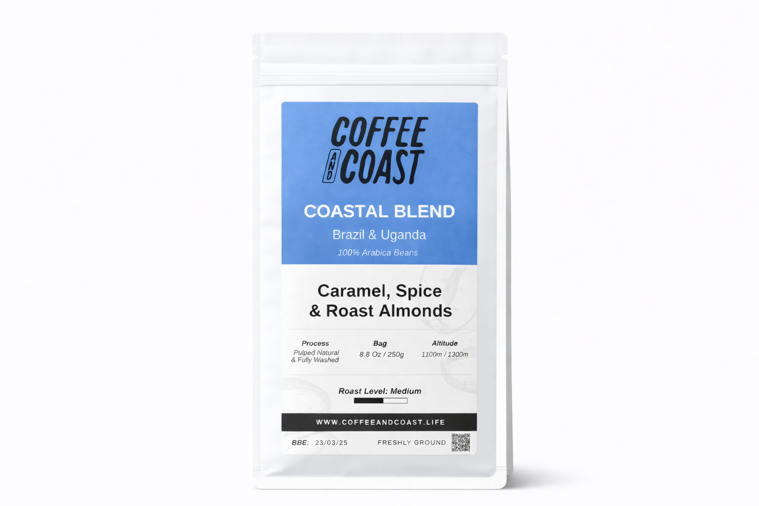 A white resealable bag of Coffee and Coast Coastal Blend coffee beans with a blue label that says 'Brazil & Uganda, 100% Arabica Beans, Caramel, Spice & Roast Almonds, Processed, Bag 8.8 oz / 250g, Altitude 1100m / 1300m, Roast Level: Medium, www.coffeeandcoast.life, BBE: 23/03/25, Freshly Ground'.