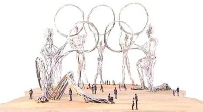 Sketch of the Olympic rings held by large skeletal figures with people walking around in an open area.