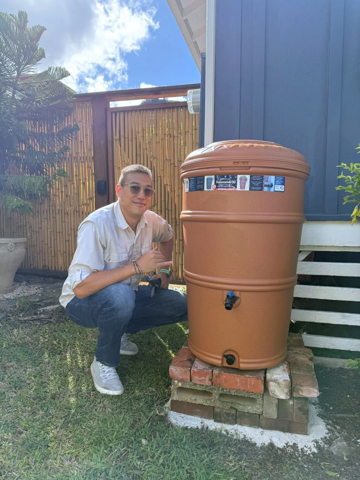 Cyrus Howe of Hawaii Green Growth with a completed rain barrel project that started out with their free rainwater assessment for Ala Wai watershed residents