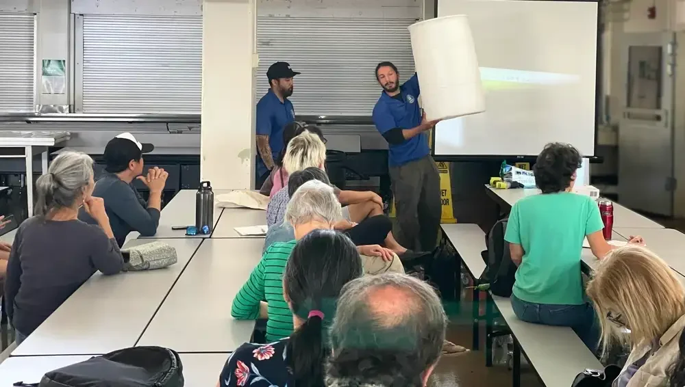 Community members learn about rain barrels from the State Department of Facility Maintenance Storm Water Quality Branch at the Smart Yards 2023 Workshop hosted by Mālama Maunalua and 3Rwater