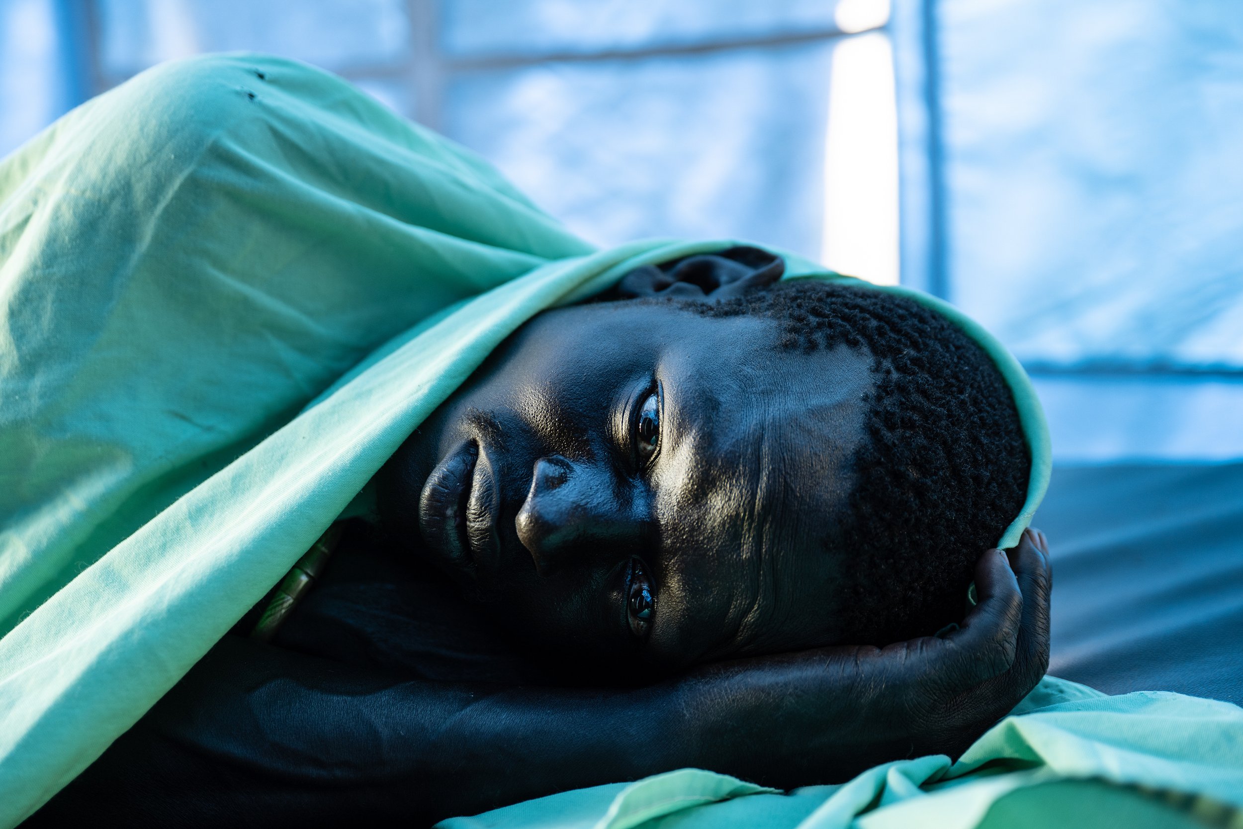  Jok Atem Deng, 31, lies ill with malaria in the health facility in the village of Paliau, one of dozens of villages flooded across Jonglei state in South Sudan, October 26, 2021.  According to the United Nations, 27 out of the 78 counties in South S