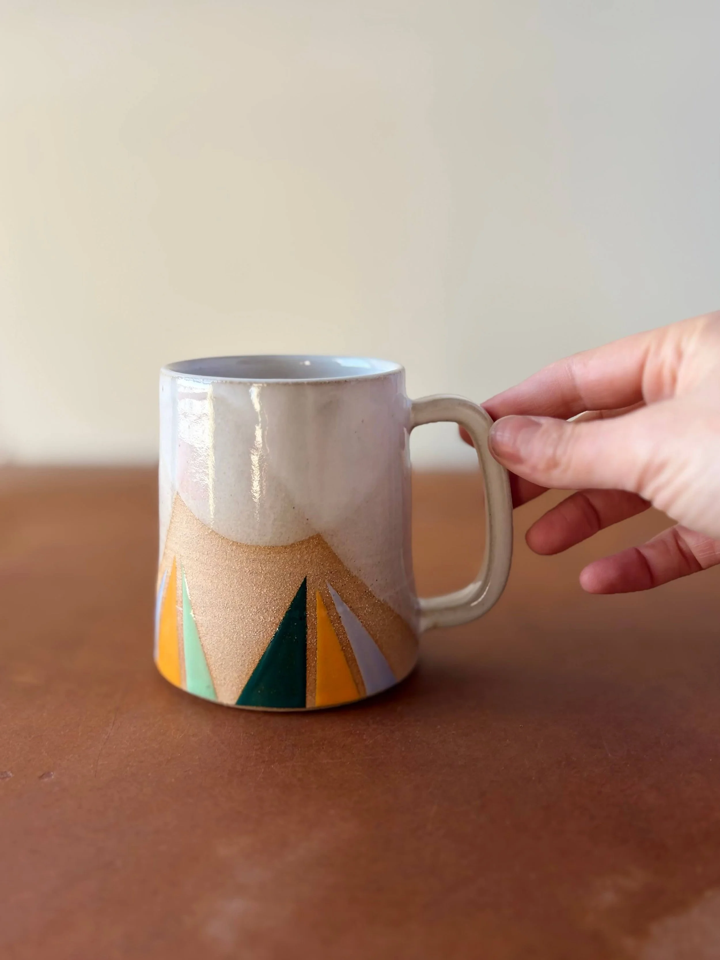 spring2026_triangles_mug_hand.jpeg