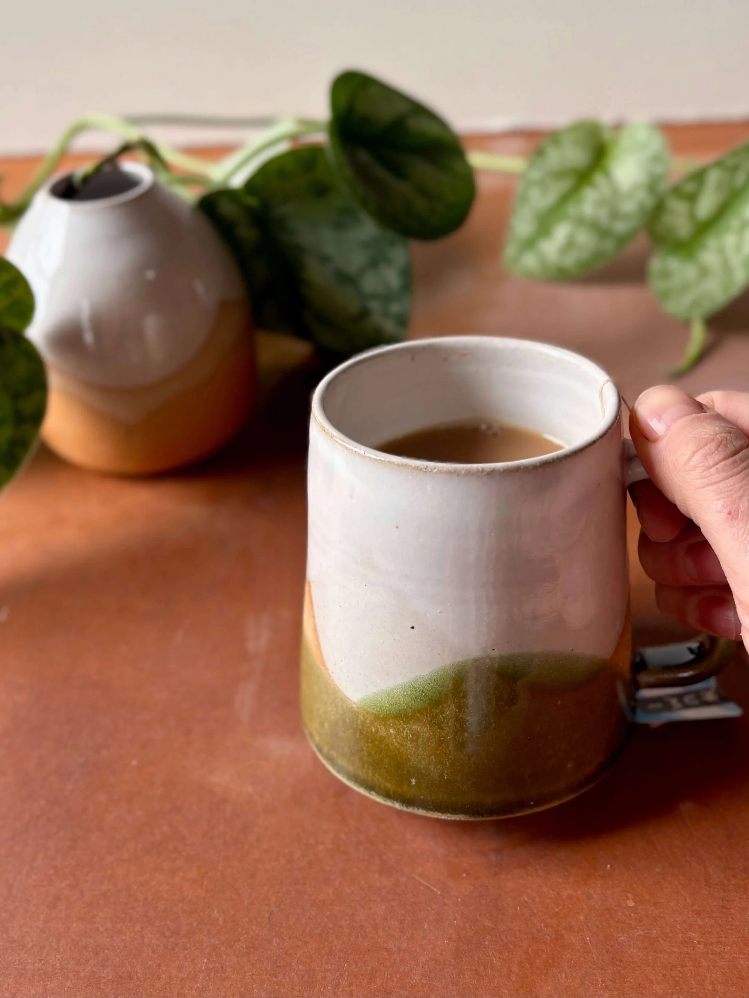 grove_mug_held_w_tea.jpg