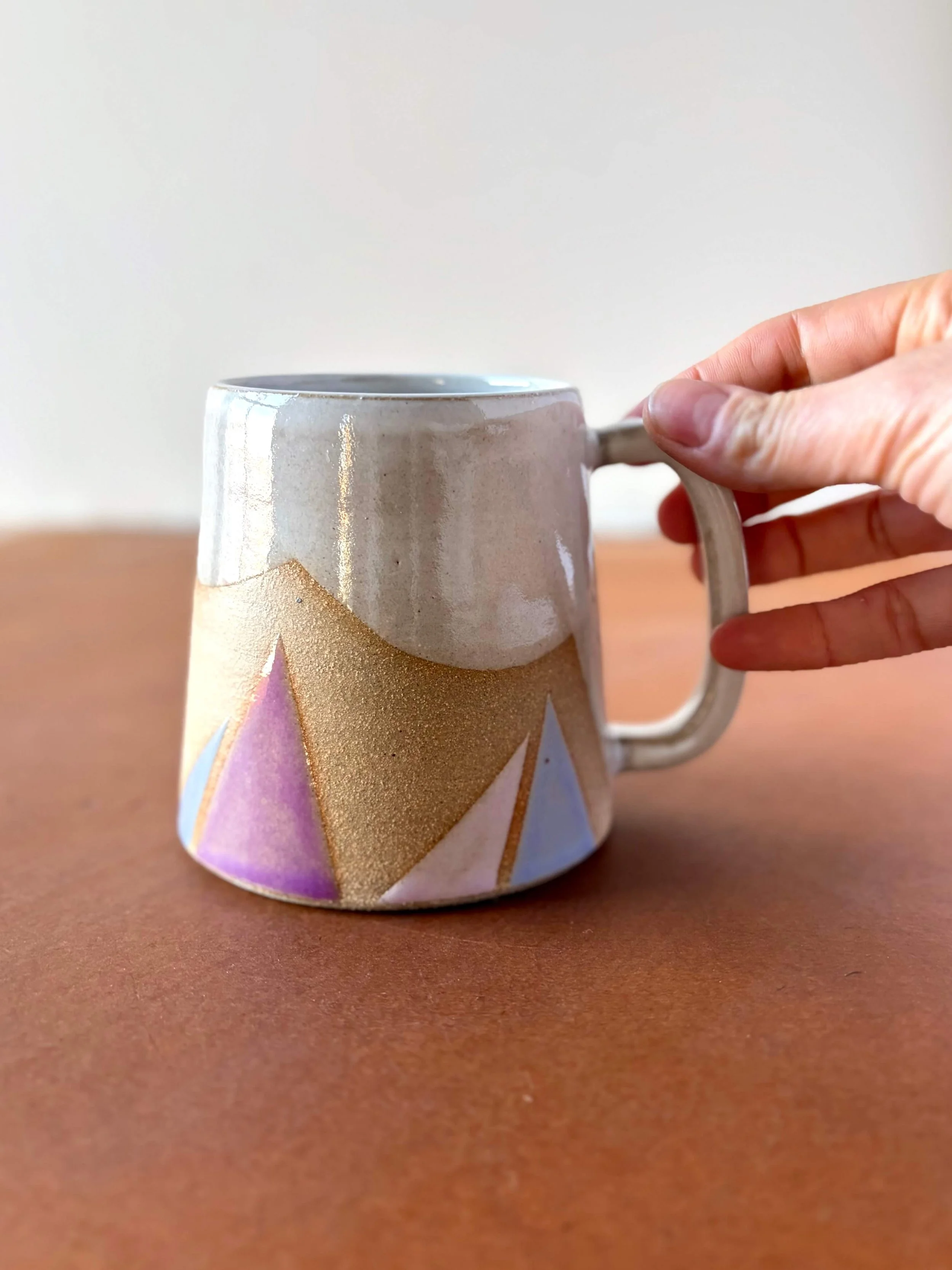 traingle_mug_purple_hand.jpeg