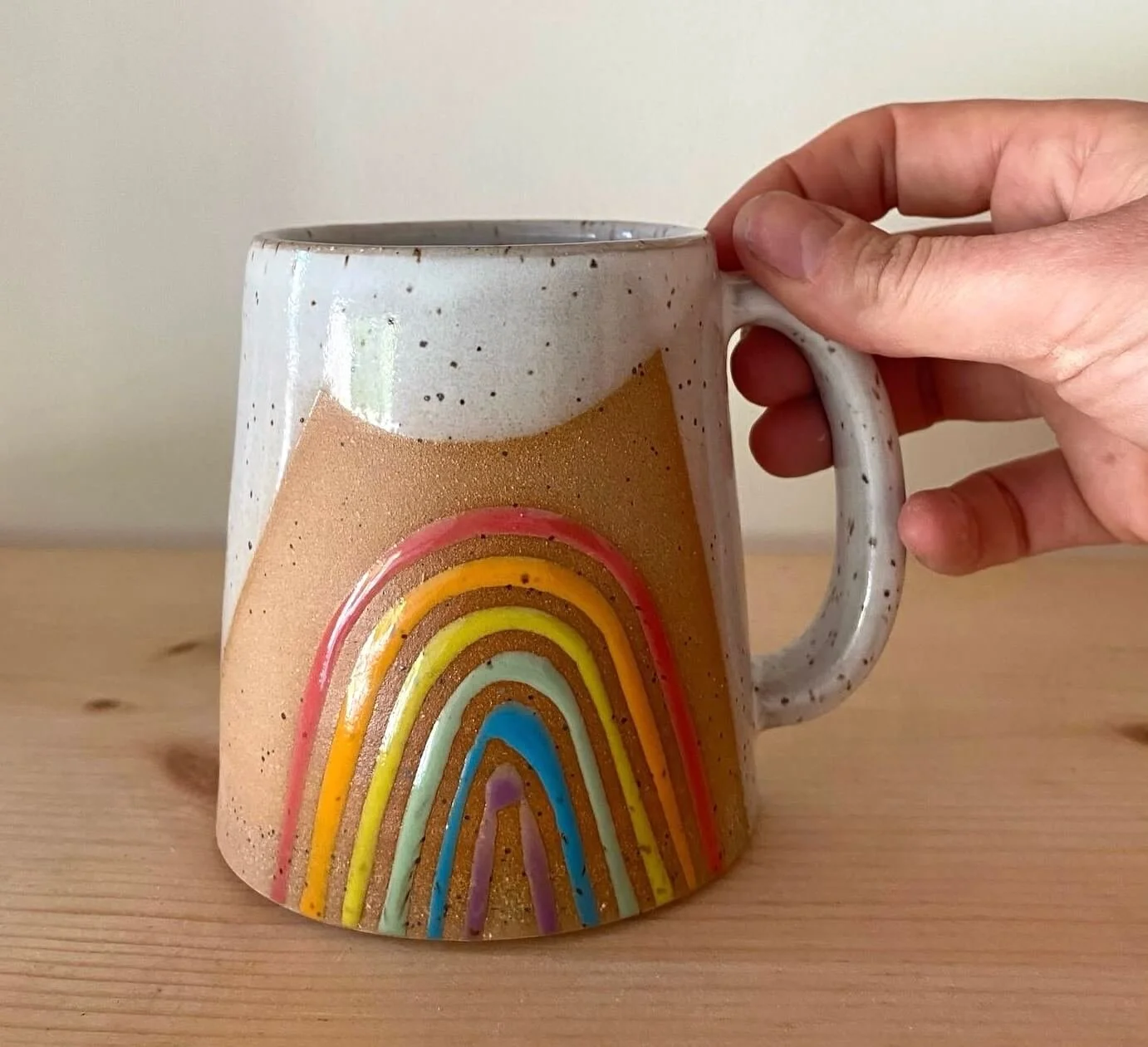 rainbow_mug_w_hand.jpg