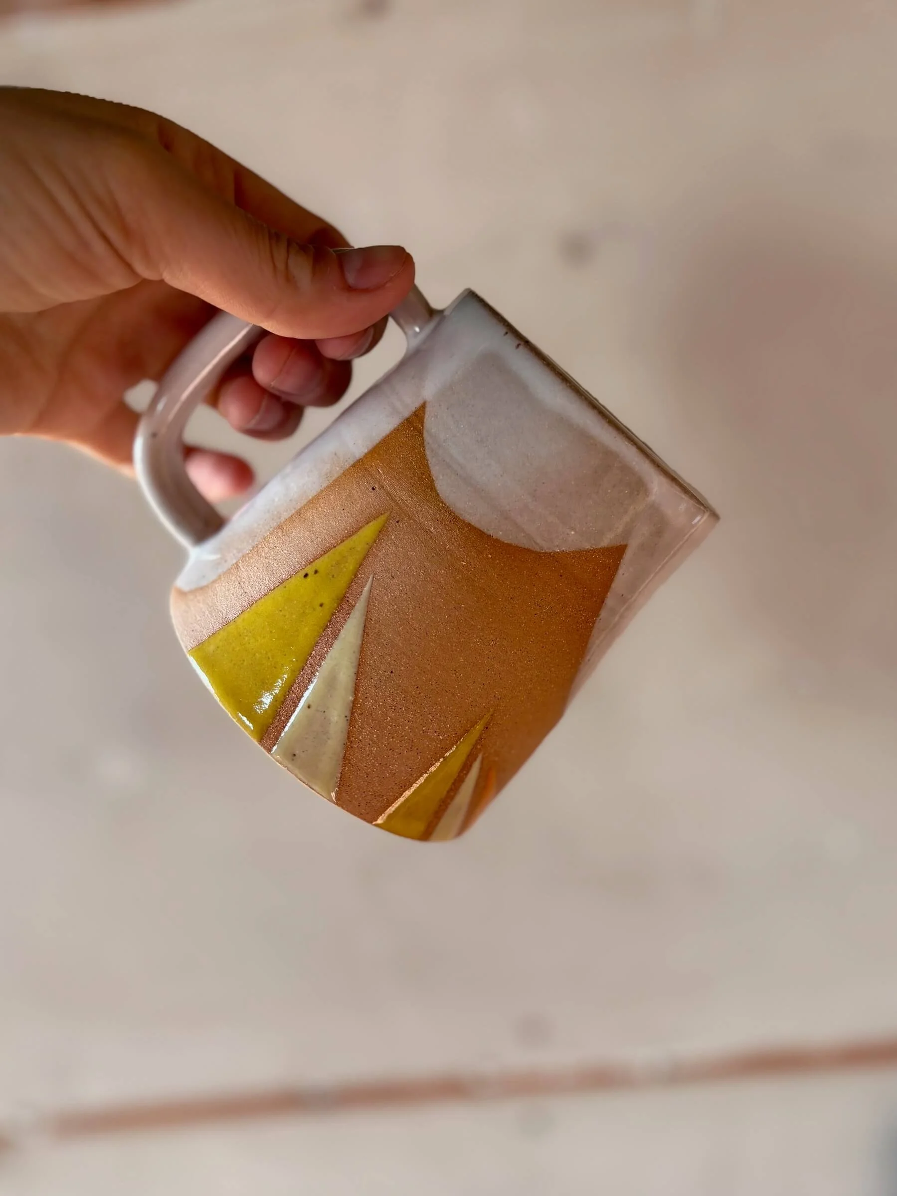 traingle_mug_yellow_hand.jpg