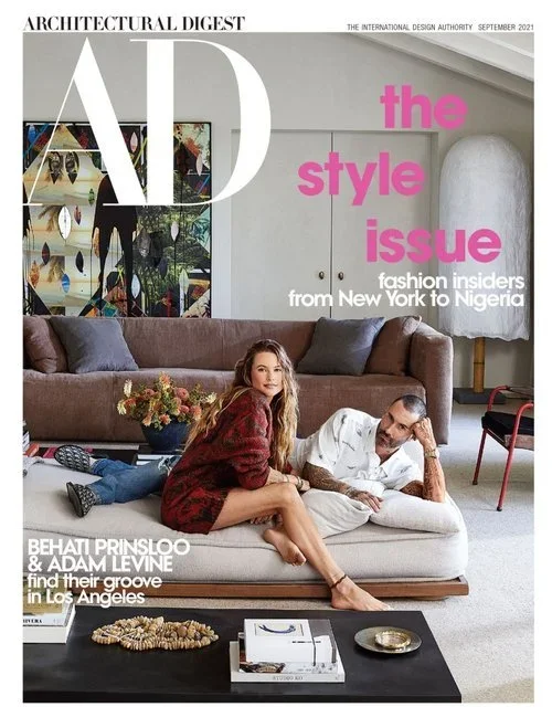 Cover of Architectural Digest magazine, September 2021 issue, titled 'the style issue'. Features Behat Prinsloo and Adam Levine lounging on a sofa in a modern living room, with framed artwork on the wall and decorative objects on a coffee table.
