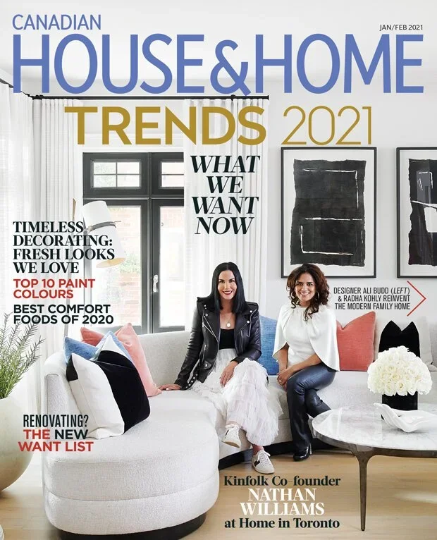 Cover of Canadian House & Home magazine, January/February 2021 issue, featuring two women sitting on a modern white sofa in a decorated living room with black framed artwork, white curtains, and colorful pillows.