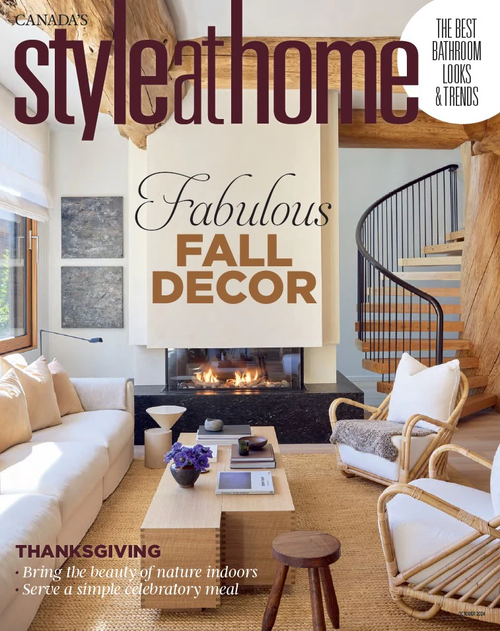 February/March 2024 issue of Canada's Style at Home magazine showcasing fall decor, a cozy living room with a fireplace, white sofa, wooden coffee table, armchairs, and a spiral staircase.